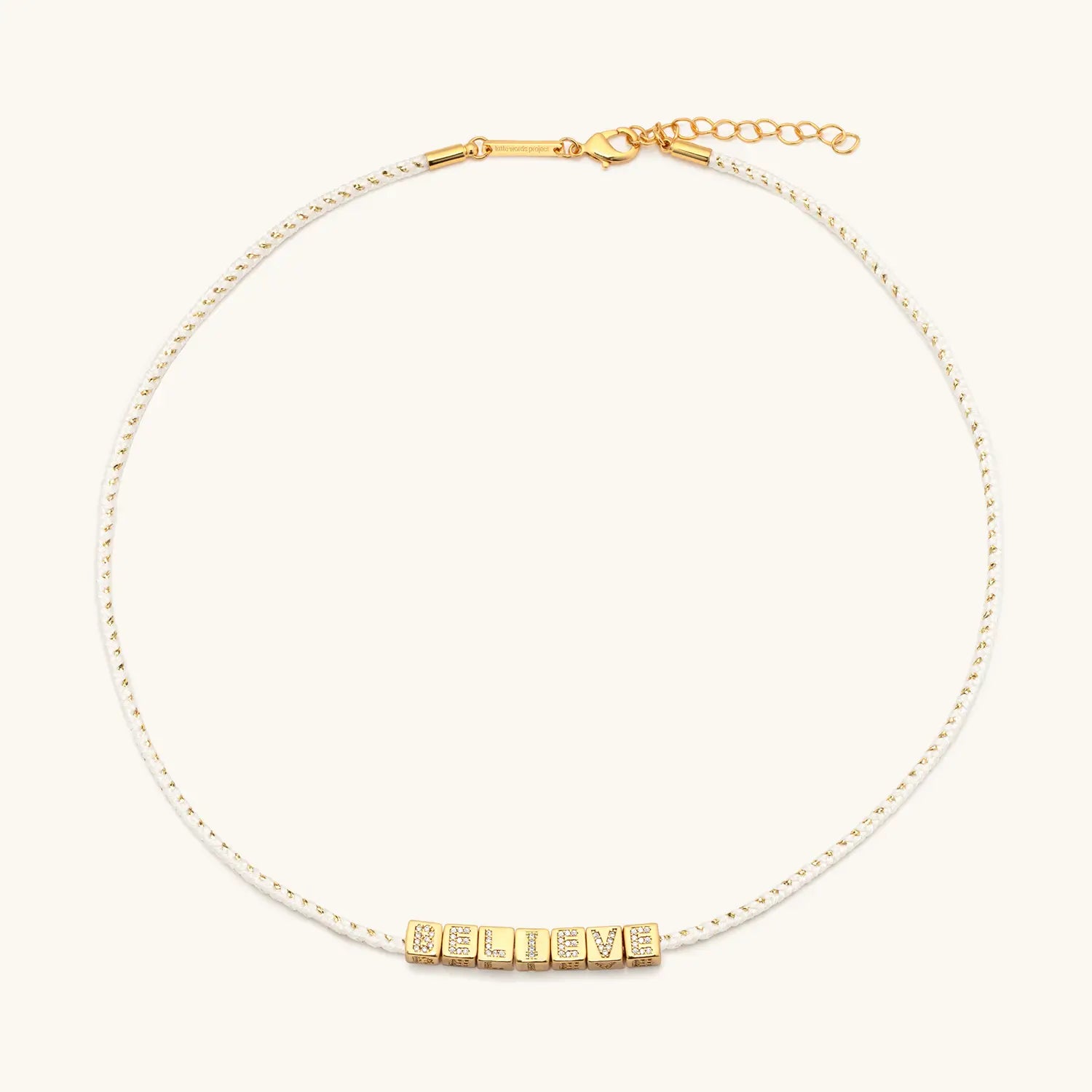Gold necklace with letters on a white background