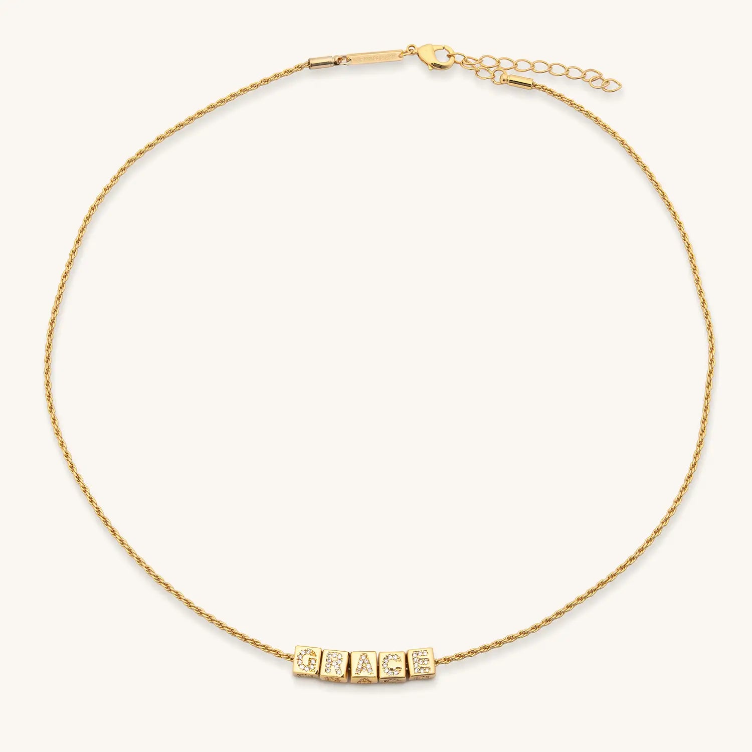 Gold necklace with 'Grace' on a white background