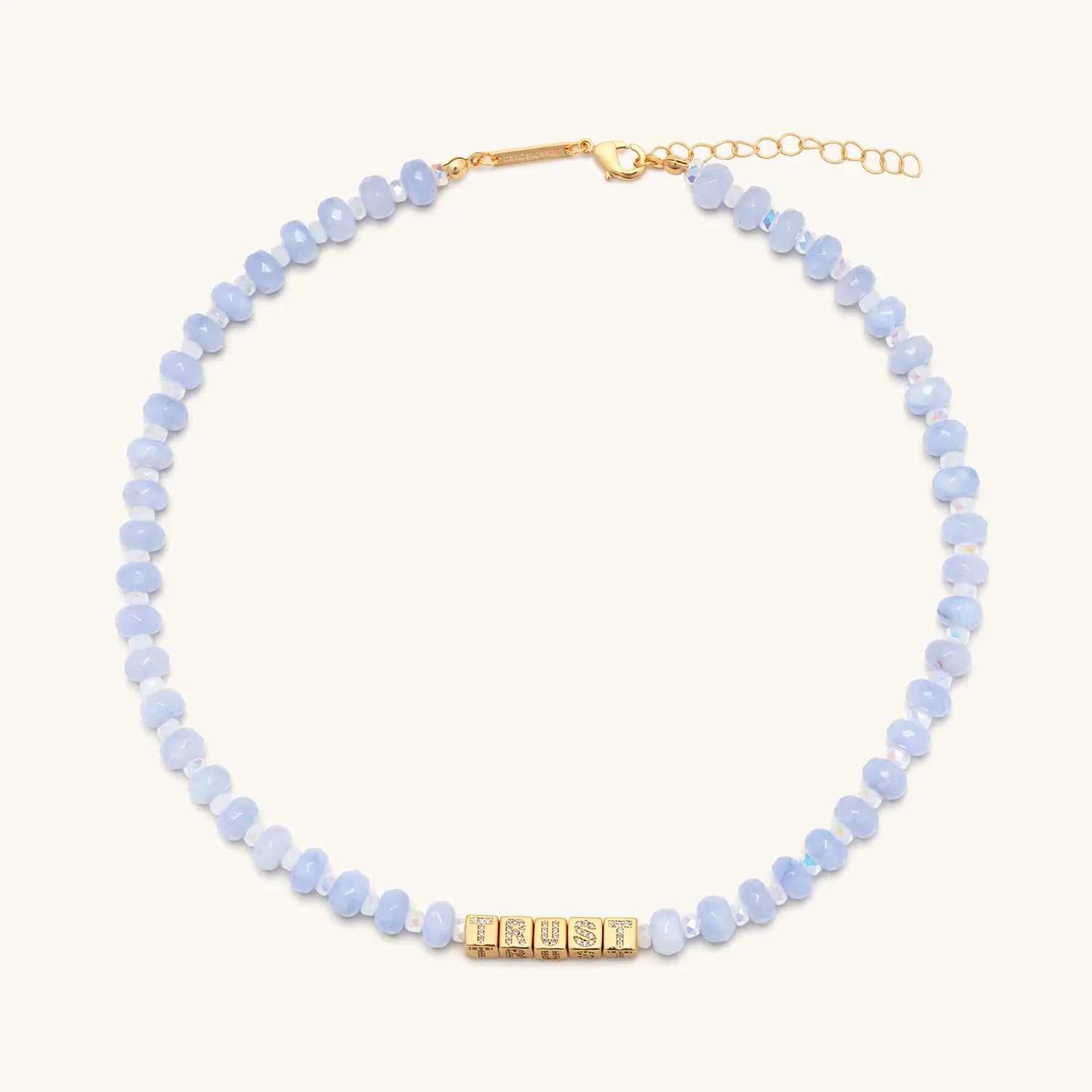 Necklace with light blue beads and gold clasp on a white background
