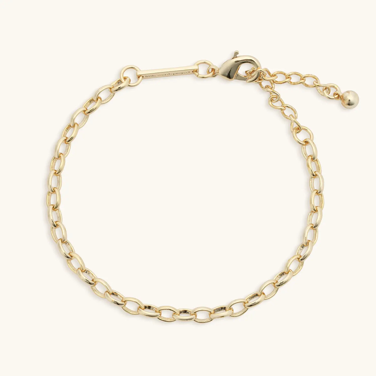 Rolo Chain Bracelet, gold plated rolo link chain bracelet with lobster claw closure and extender, flat-lay on cream background