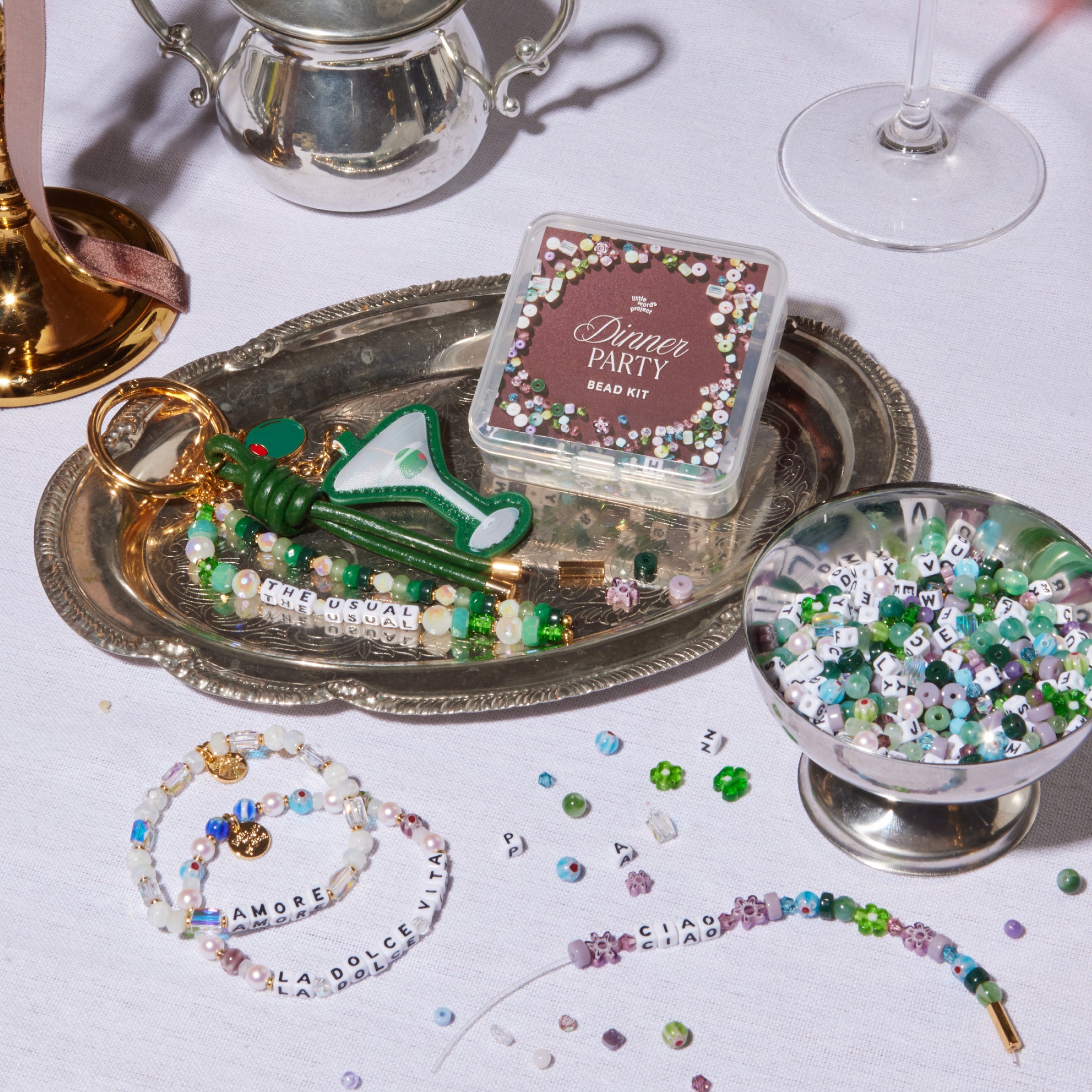 Jewelry-making kit with beads and tools on a tablecloth