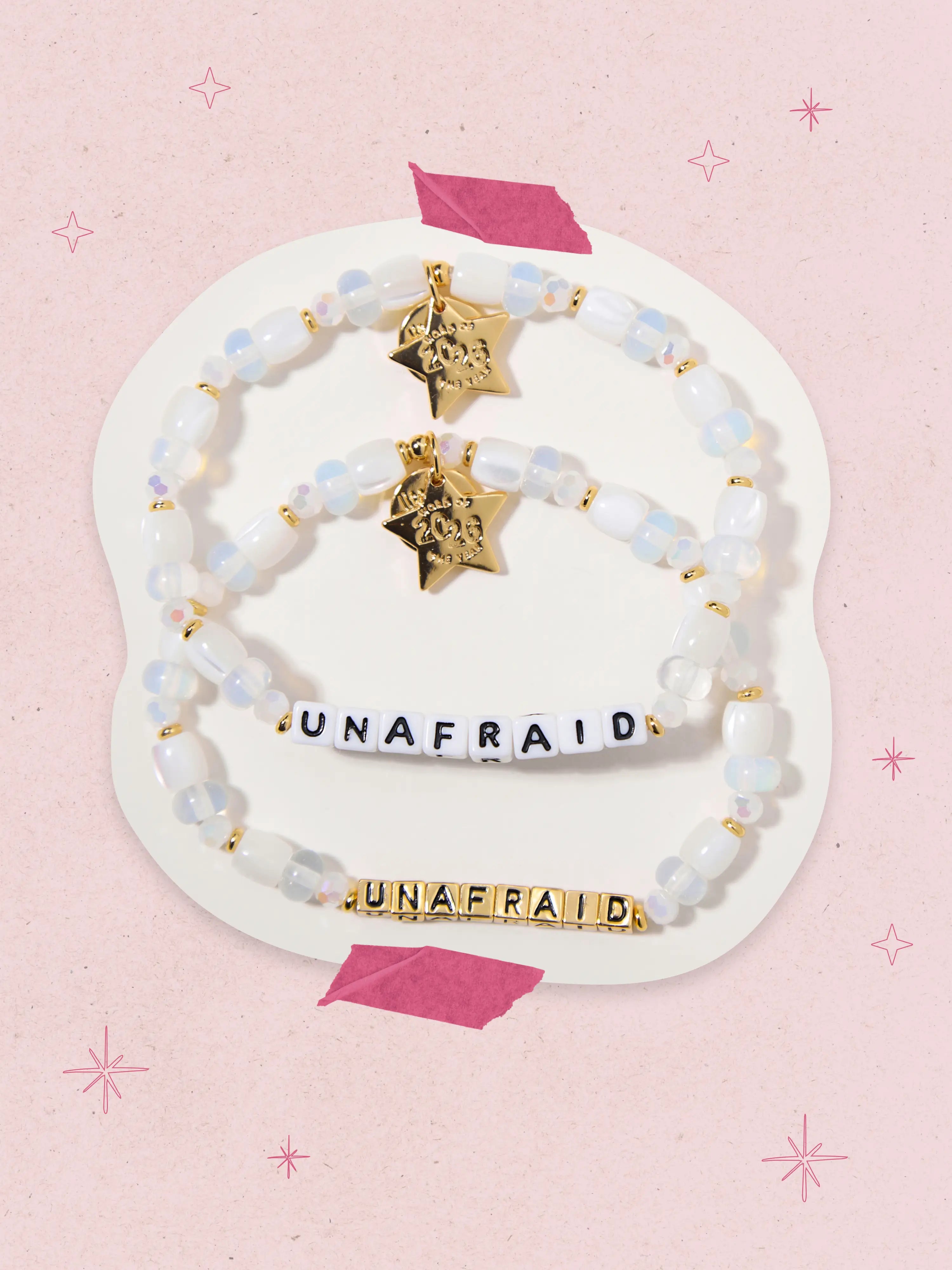 Bracelets with 'UNAFRAID' on a pink background