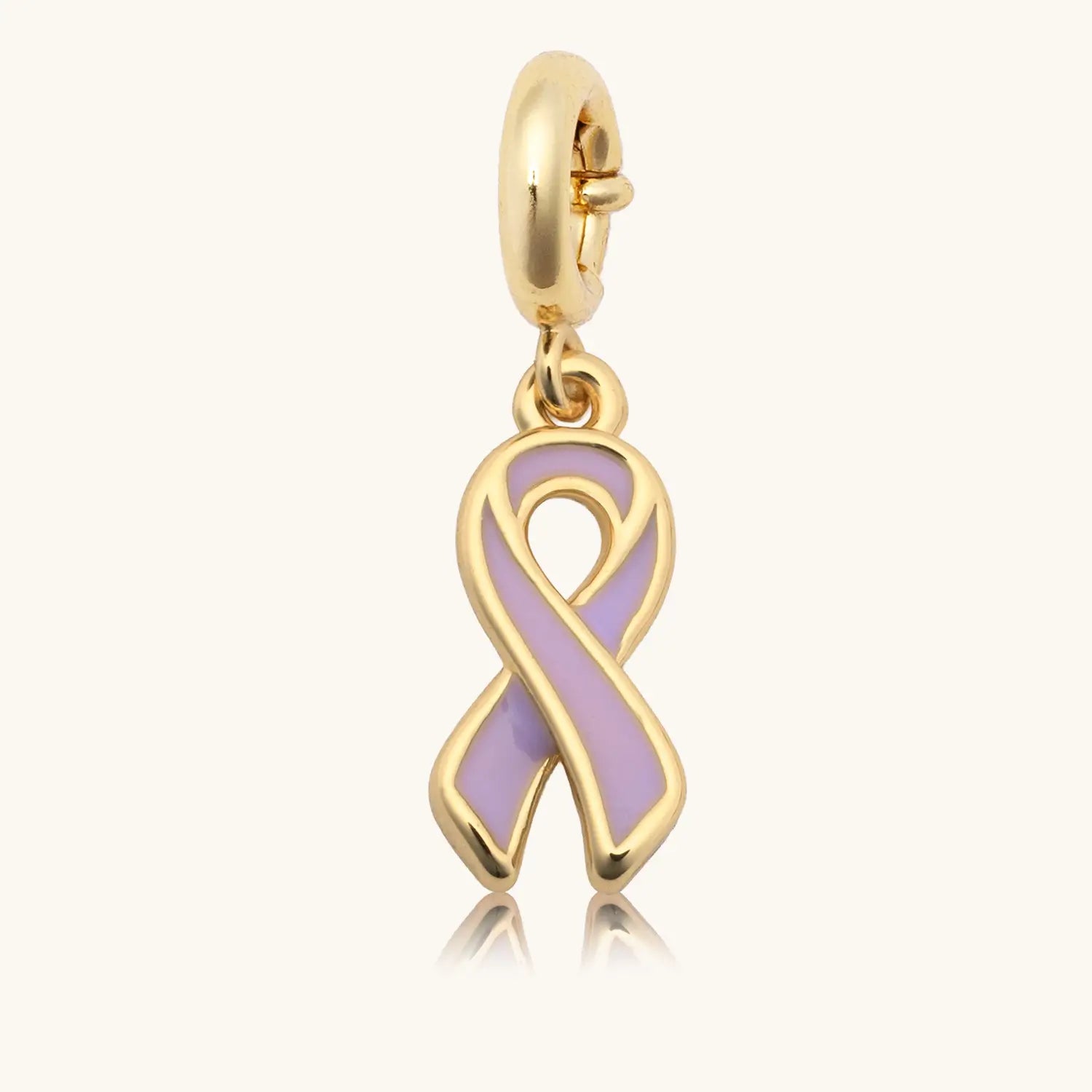 Gold charm with a purple ribbon on a white background
