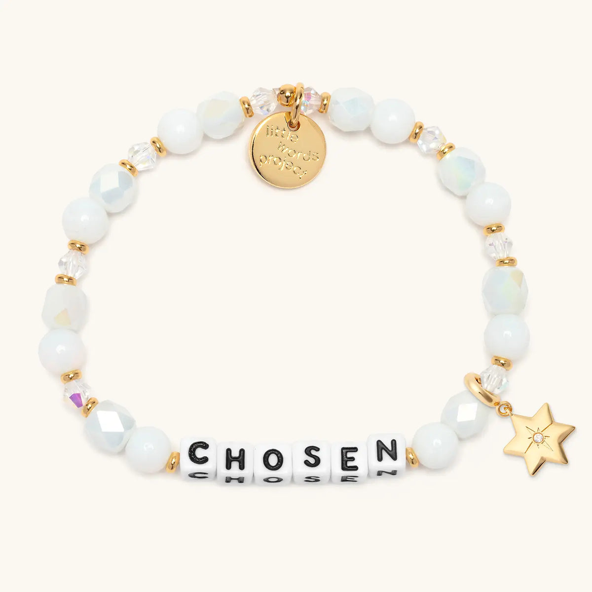 Chosen bracelet in the Snow Fantasy bead pattern with white letter beads, gold puffy Star of David charm with a clear CZ stone, flat-lay on cream background