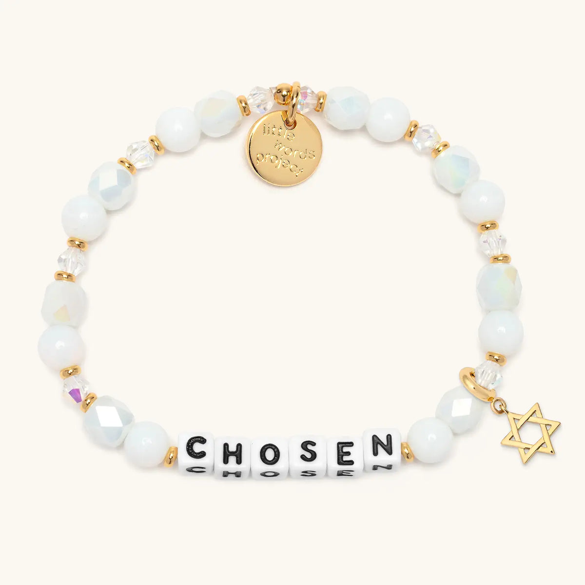 Chosen bracelet in the Snow Fantasy bead pattern with white letter beads, gold Star of David charm, flat-lay on cream background