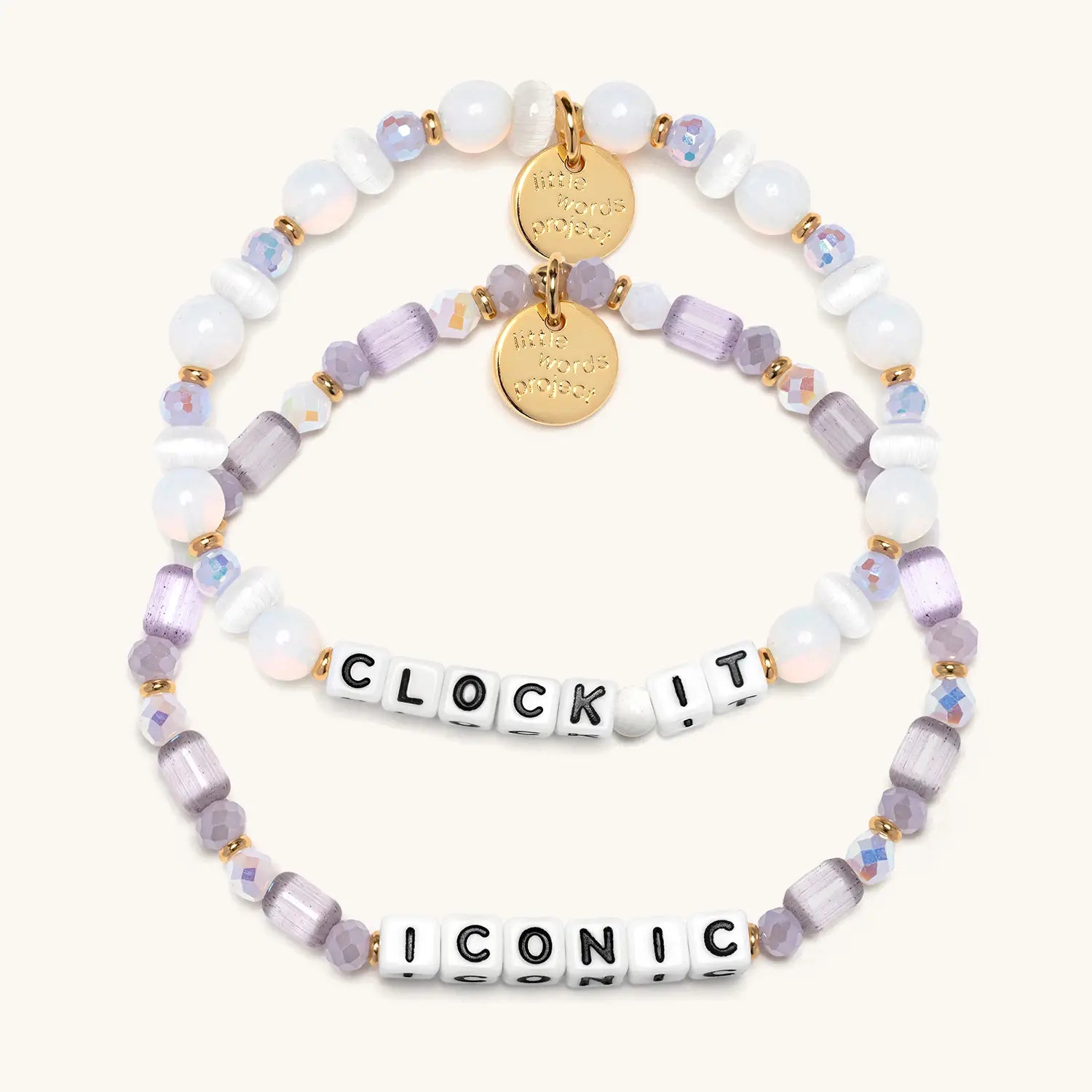 Two beaded bracelets with gold tags and letter beads on a white background