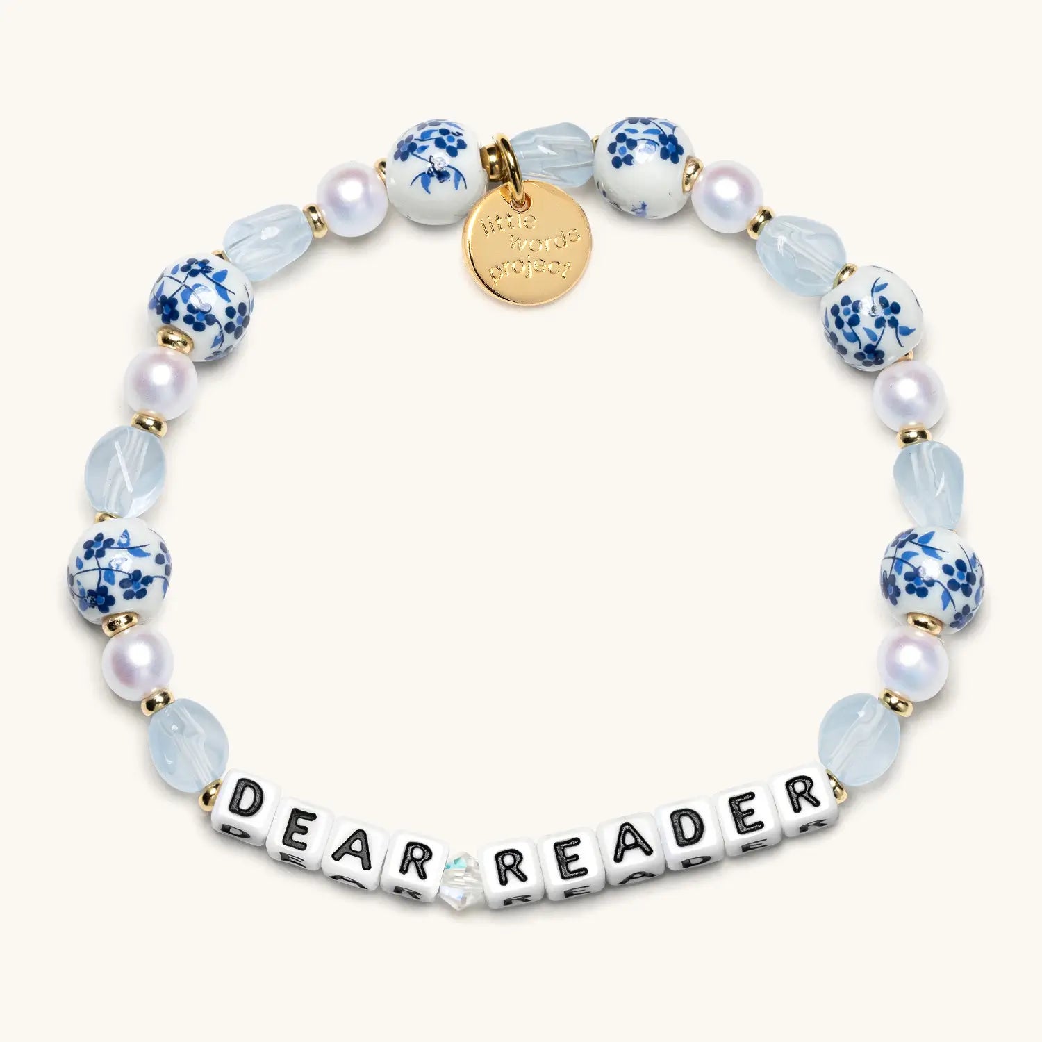 Bracelet with blue and white beads and 'DEAR READER' on a white background