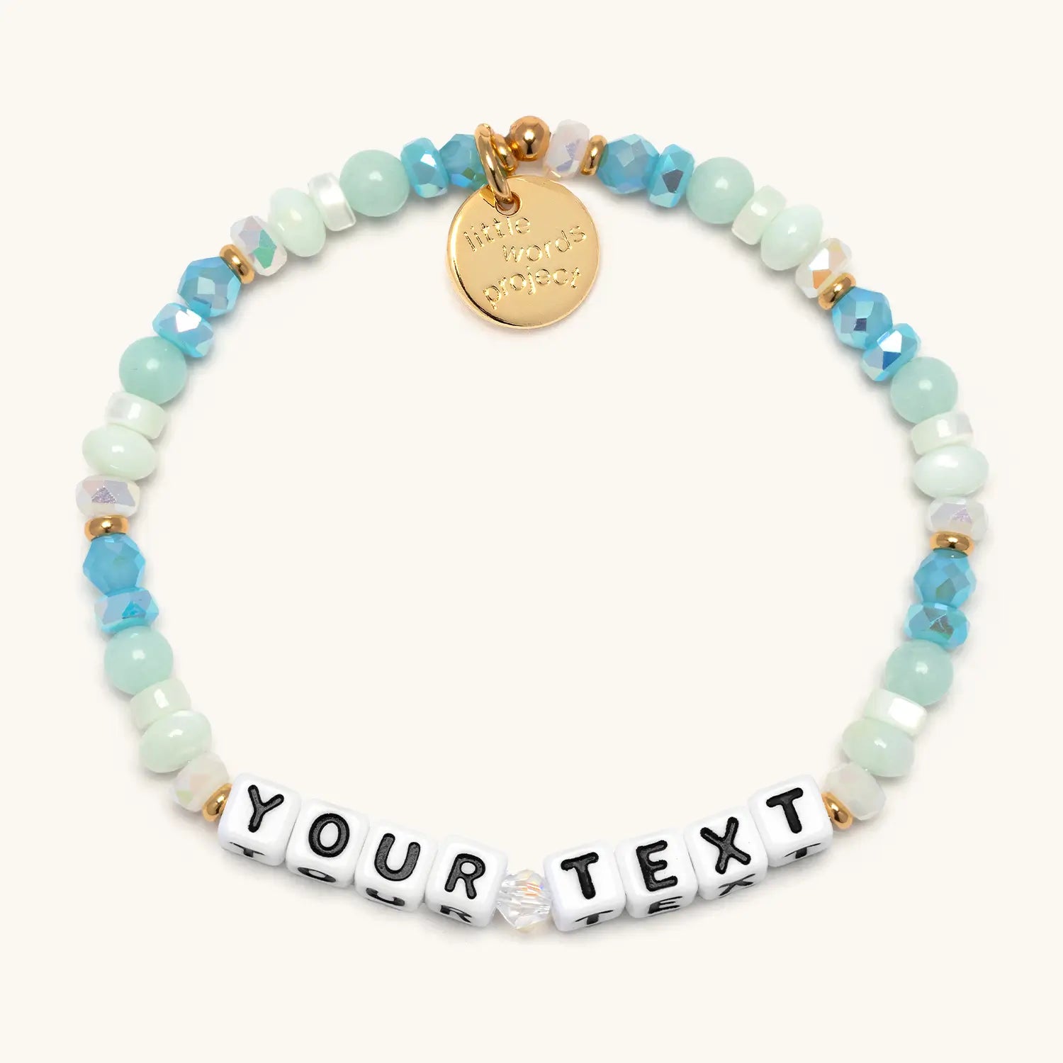 Custom Divine Favor bracelet — white letter beads on silver chain, flat-lay