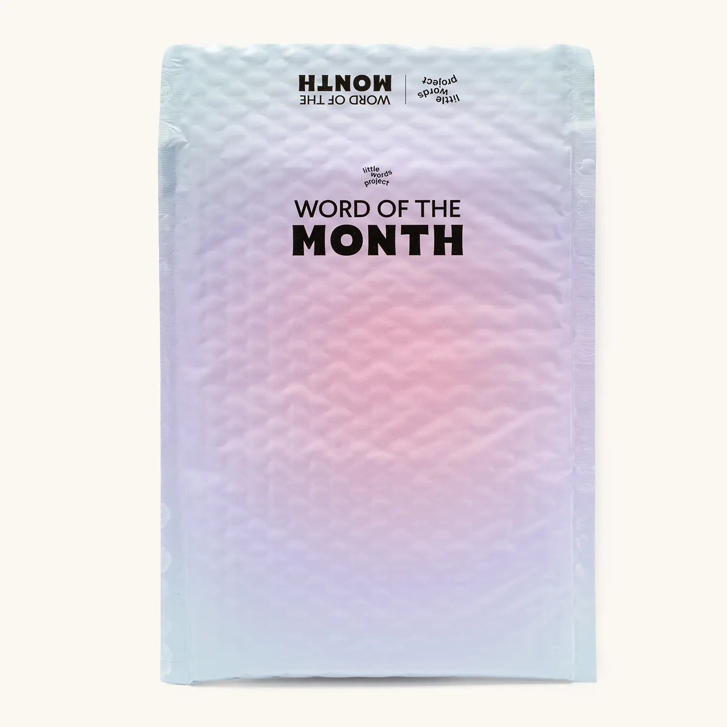 Back of the Word of the Month subscription mailer in a pastel pink and blue gradient with the Little Words Project logo