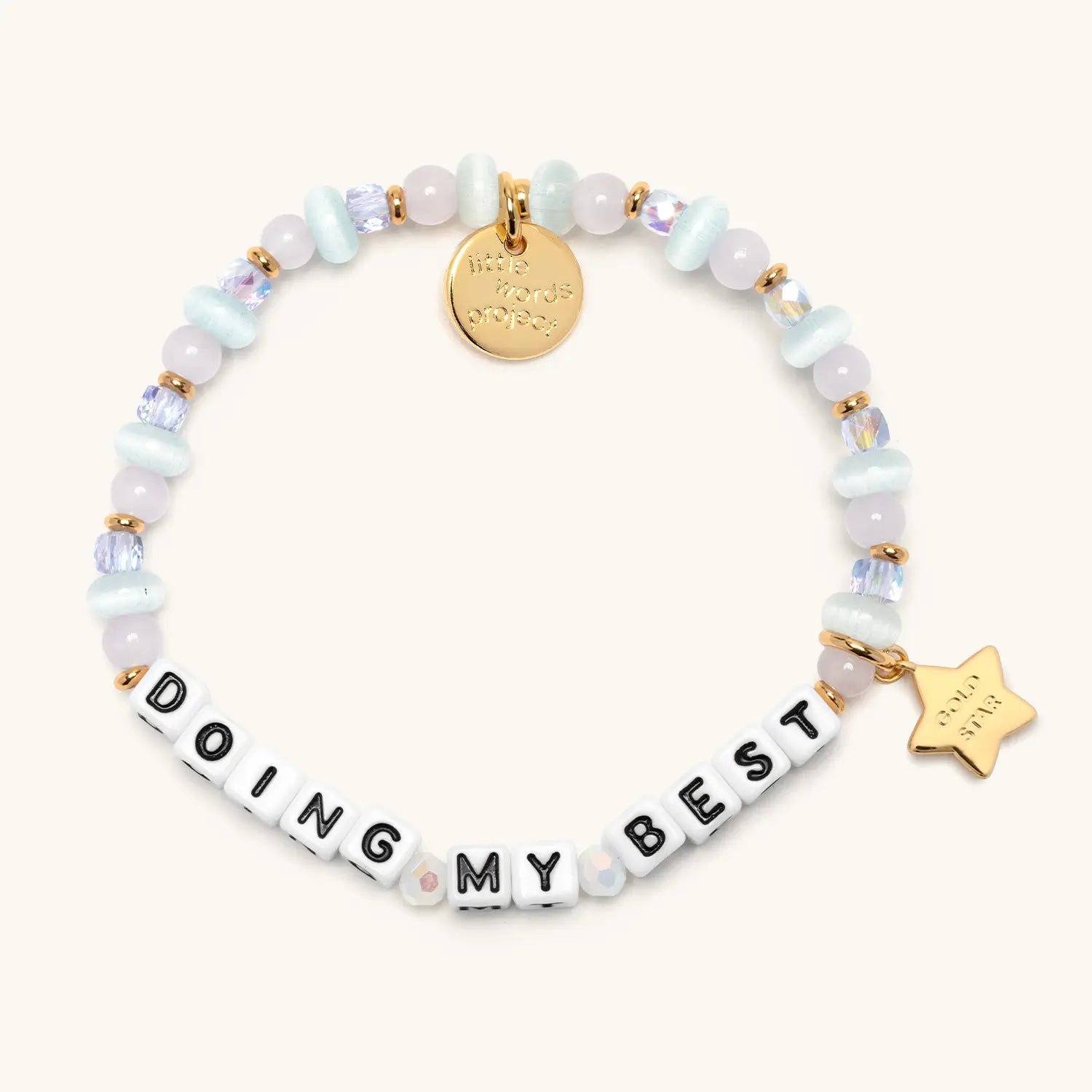 Doing My Best bracelet with pastel white, blue and pink beads, gold letter beads and a gold star charm, flat lay