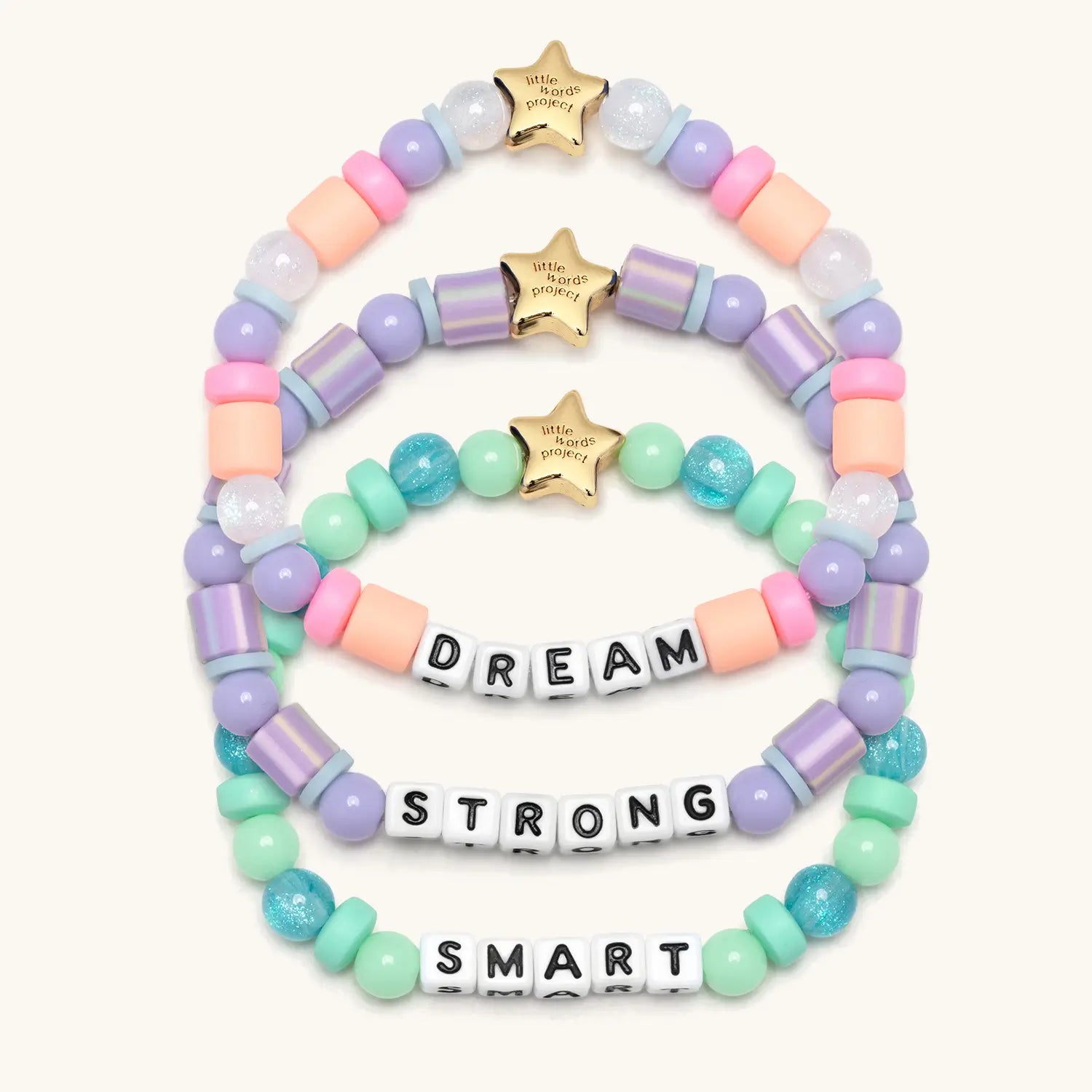 Set of colorful beaded bracelets with inspirational message beads on a white background