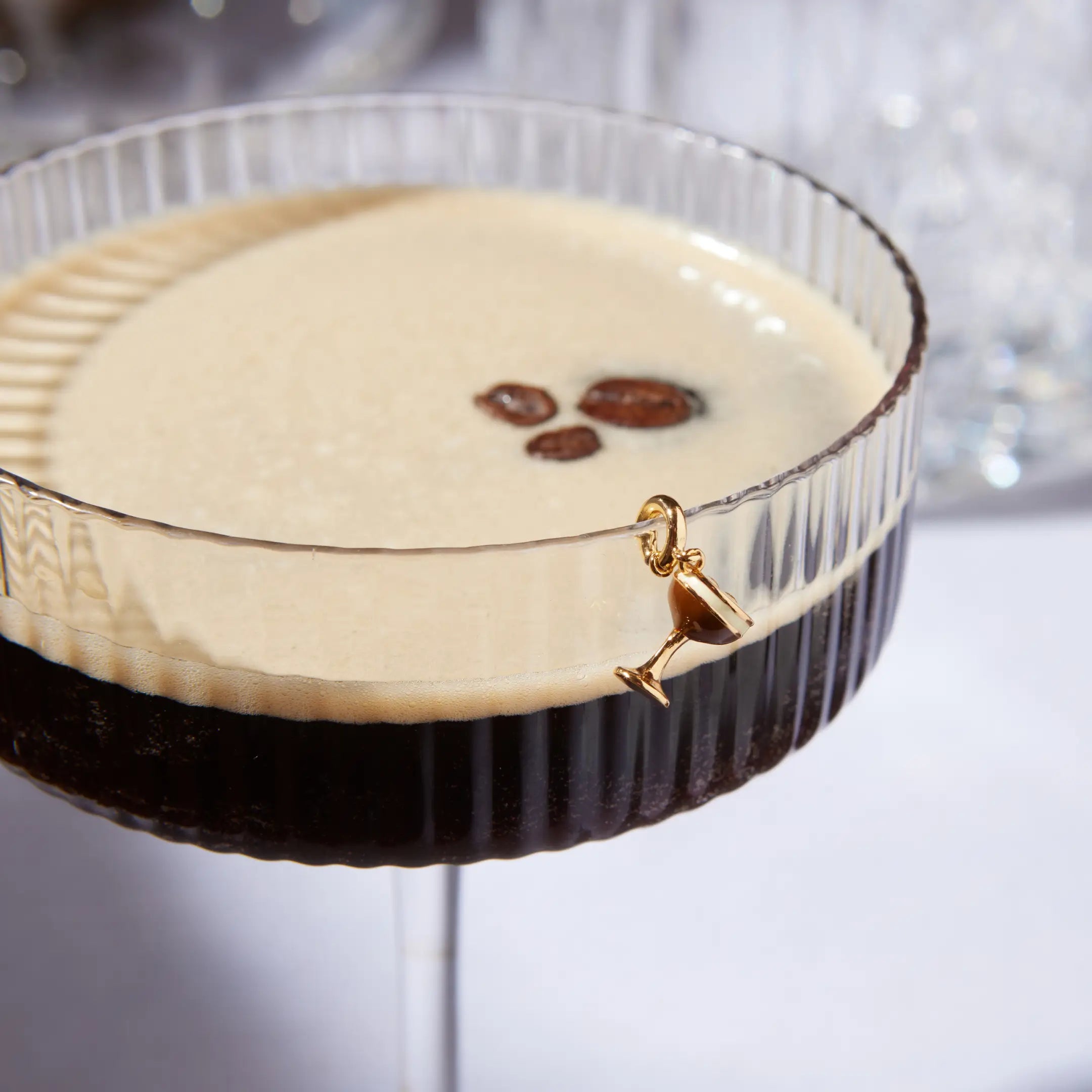 Close-up of a espresso and coffee beans in a glass on a white background