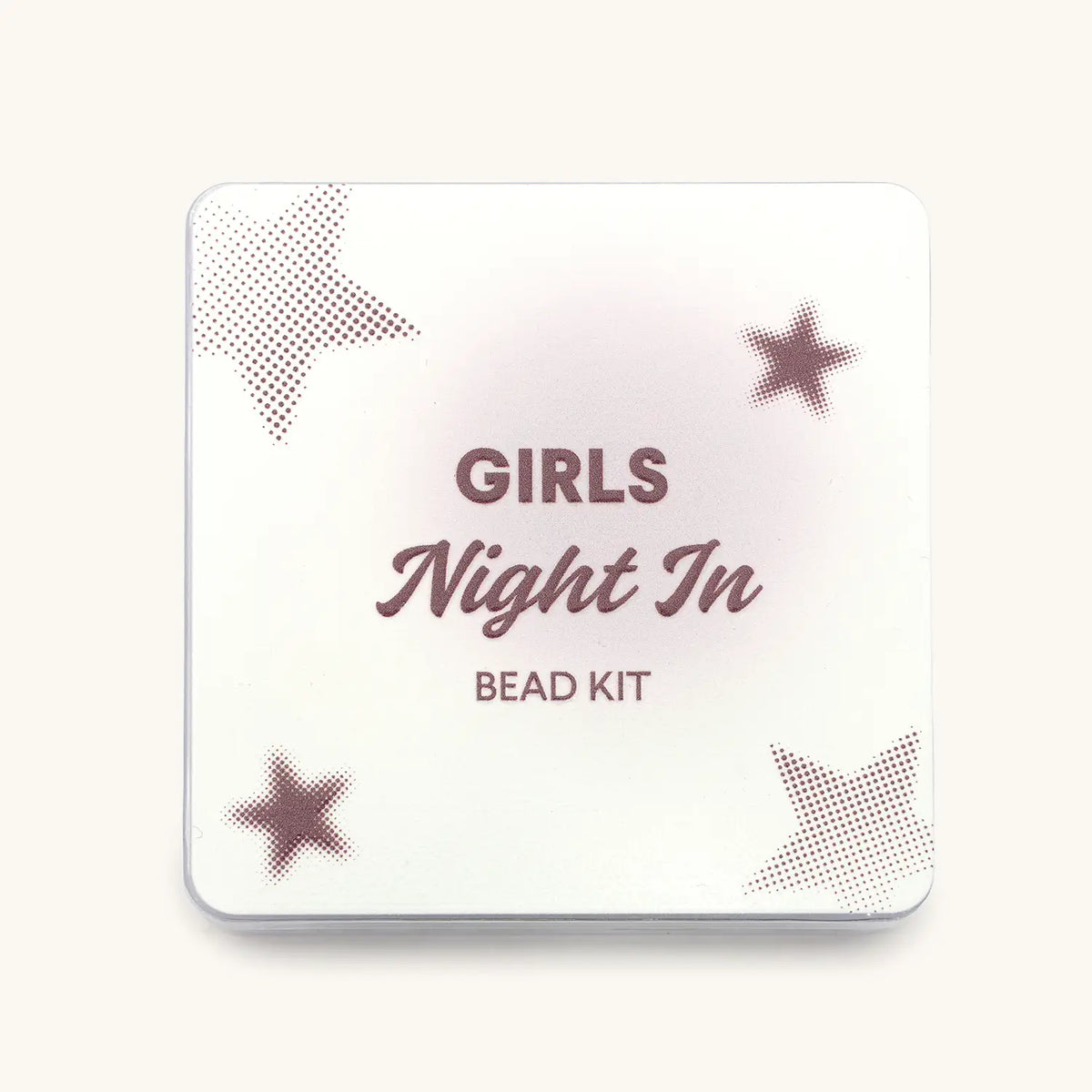 Girls Night In Bead Kit, front of the white tin with burgundy Girls Night In Bead Kit text and dotted star pattern, flat-lay on cream background
