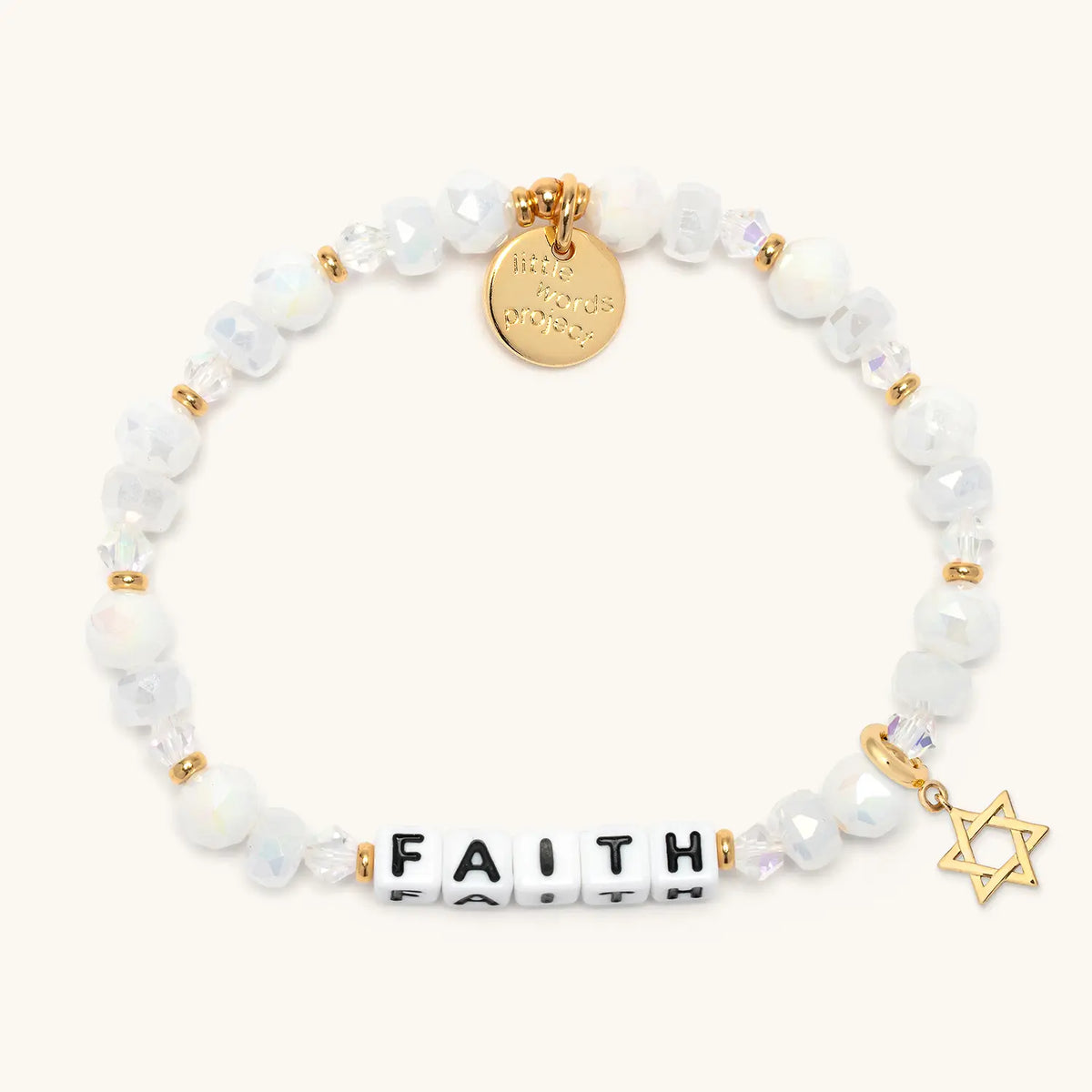 Faith bracelet in the Snowflake Sparkle bead pattern with white letter beads, gold Star of David charm, flat-lay on cream background