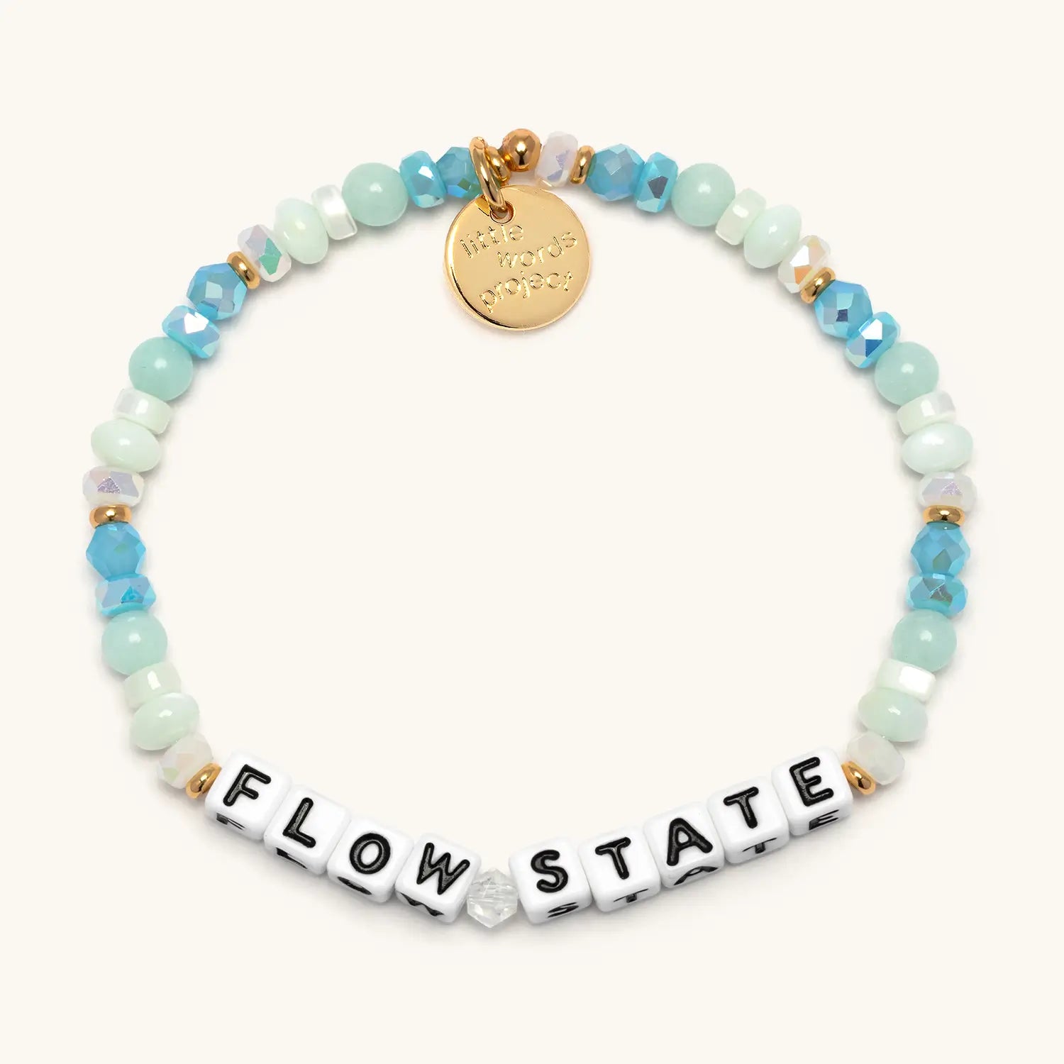 Flow State — front flat-lay of beaded word bracelet in blue and neutral beads