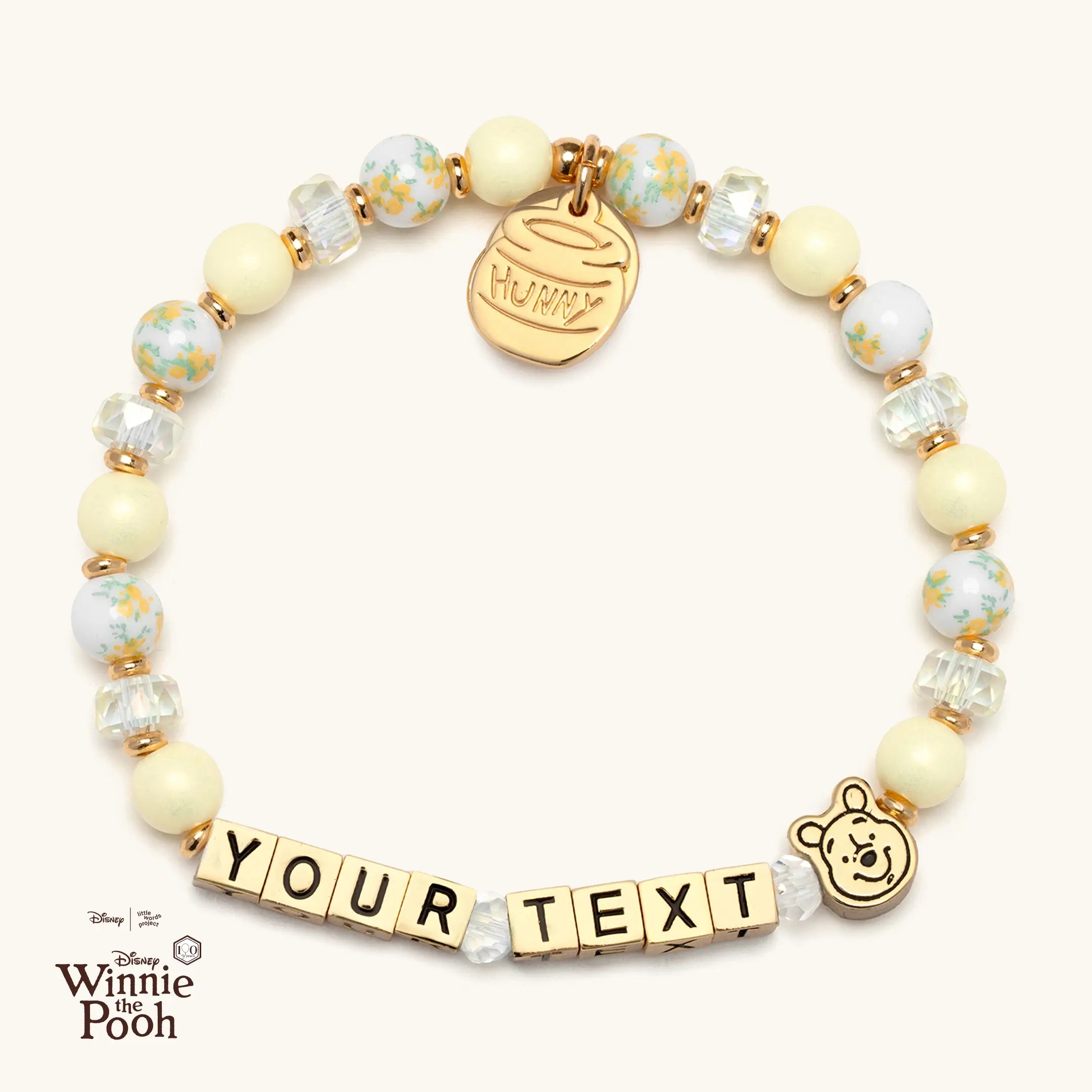 Bracelet with Winnie the Pooh character bead and customizable text on a white background
