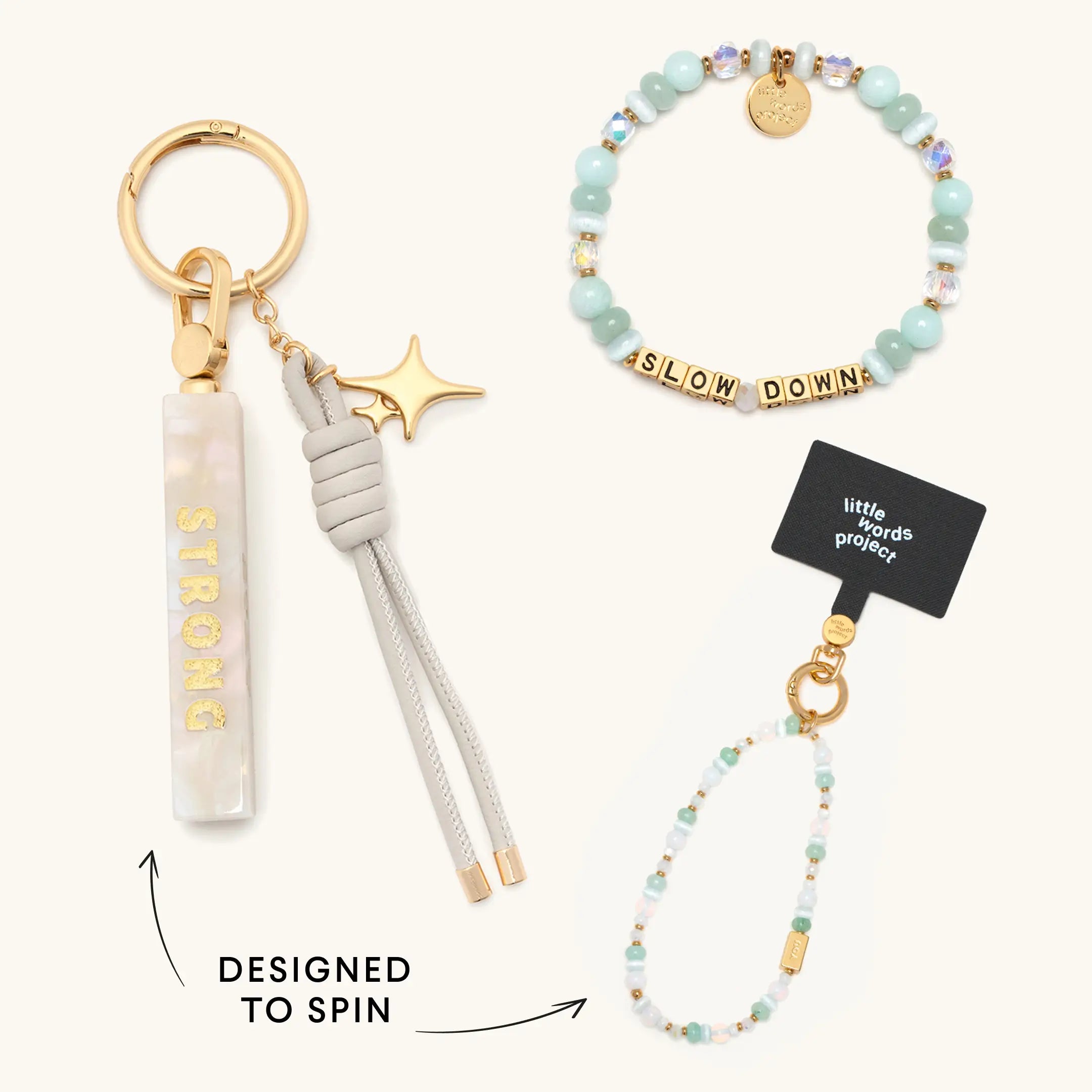 A keychain with a spinning marble bar charm and star pendant, alongside a beaded bracelet and phone strap reading "Slow Down."