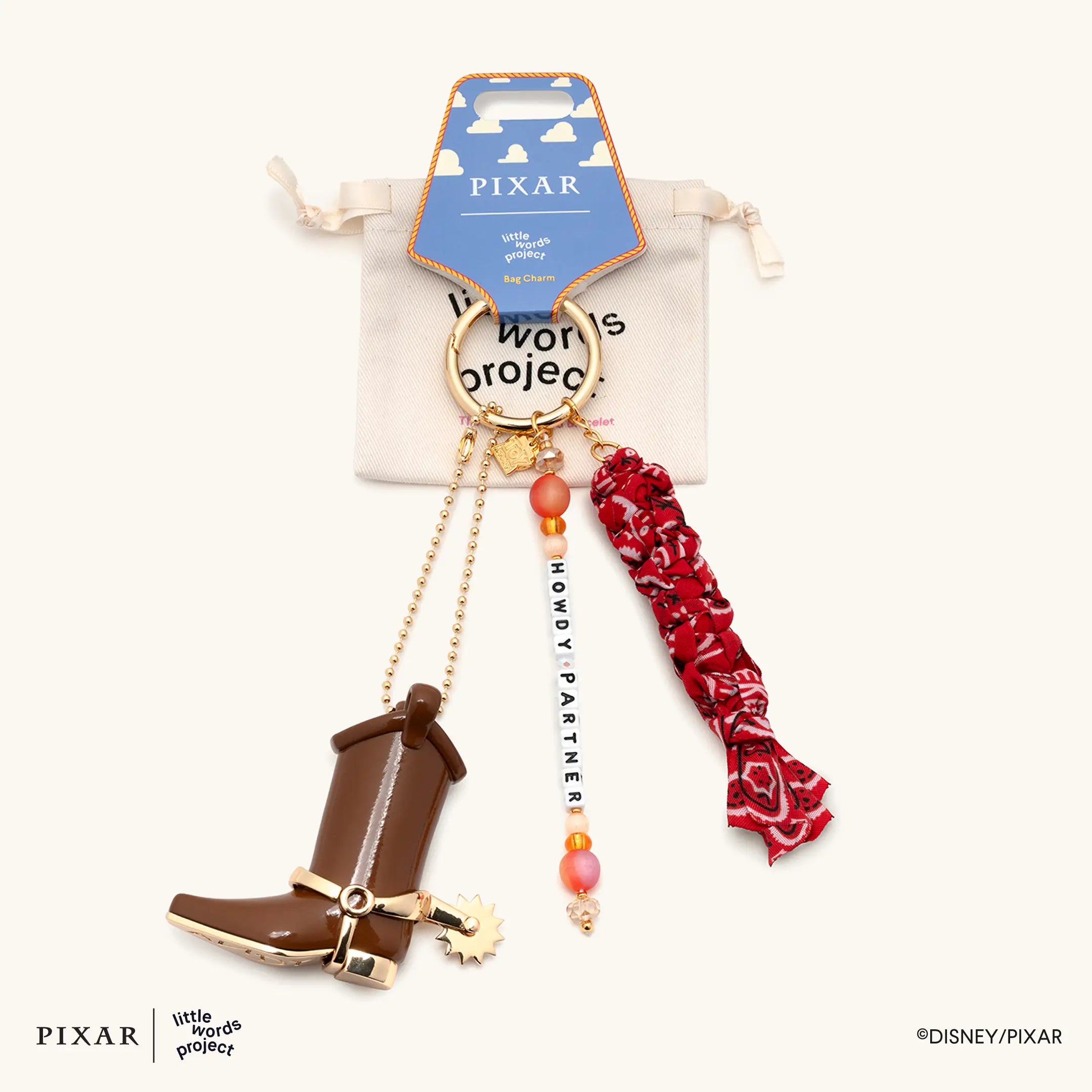 Howdy Partner Toy Story bag charm draped over a blue Pixar little words project drawstring pouch