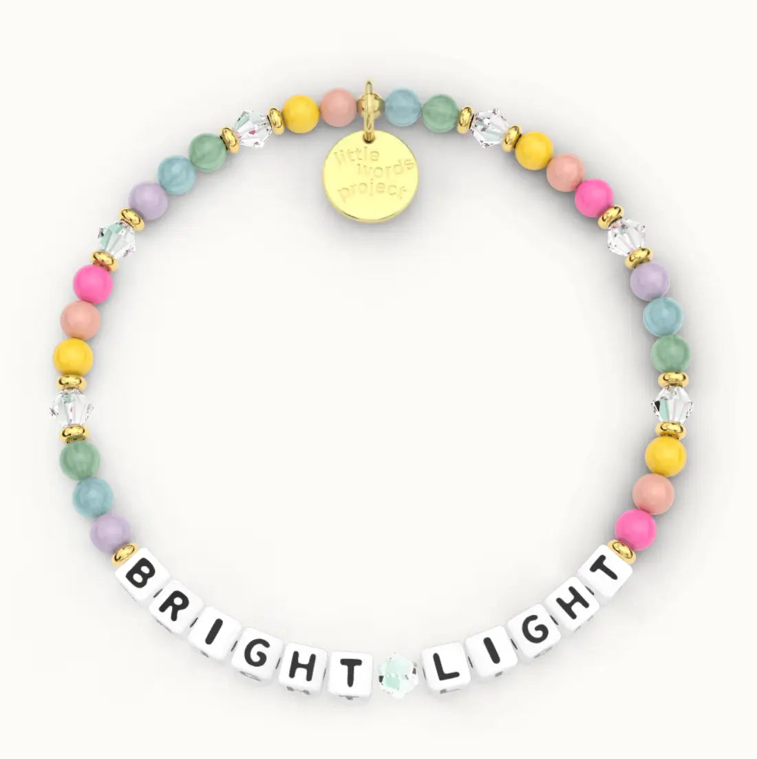 Bright Light giveback bracelet in the Sherbert bead pattern, white letter beads with pink, yellow, peach, sage, teal and lavender beads and clear crystals with gold accents, flat-lay on cream background