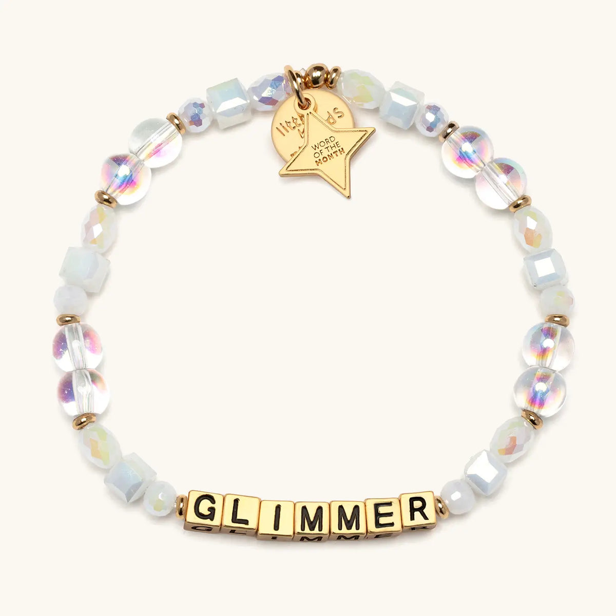 Glimmer bracelet with gold letter beads and a gold tag, from the Six Months of Intention set