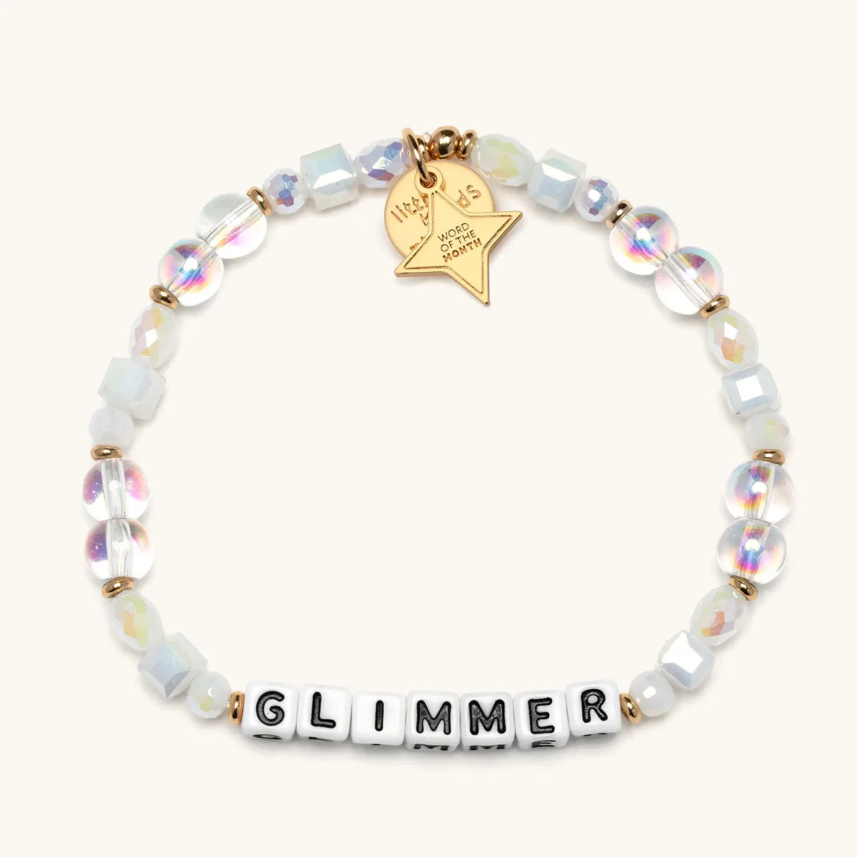 Glimmer bracelet with white letter beads and a gold tag, from the Six Months of Intention set