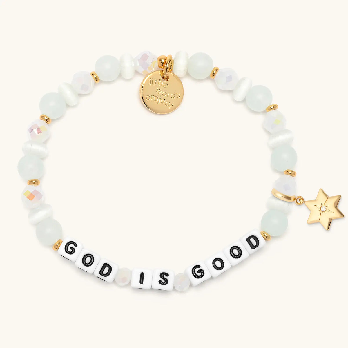 God is Good bracelet in the Luxe Knit bead pattern with white letter beads, gold puffy Star of David charm with a clear CZ stone, flat-lay on cream background