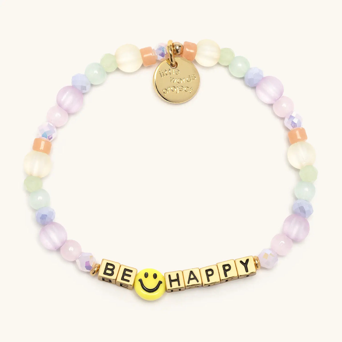 Be Happy bracelet with gold letter beads from the Good as Gold Bracelet Set, flat-lay on cream background