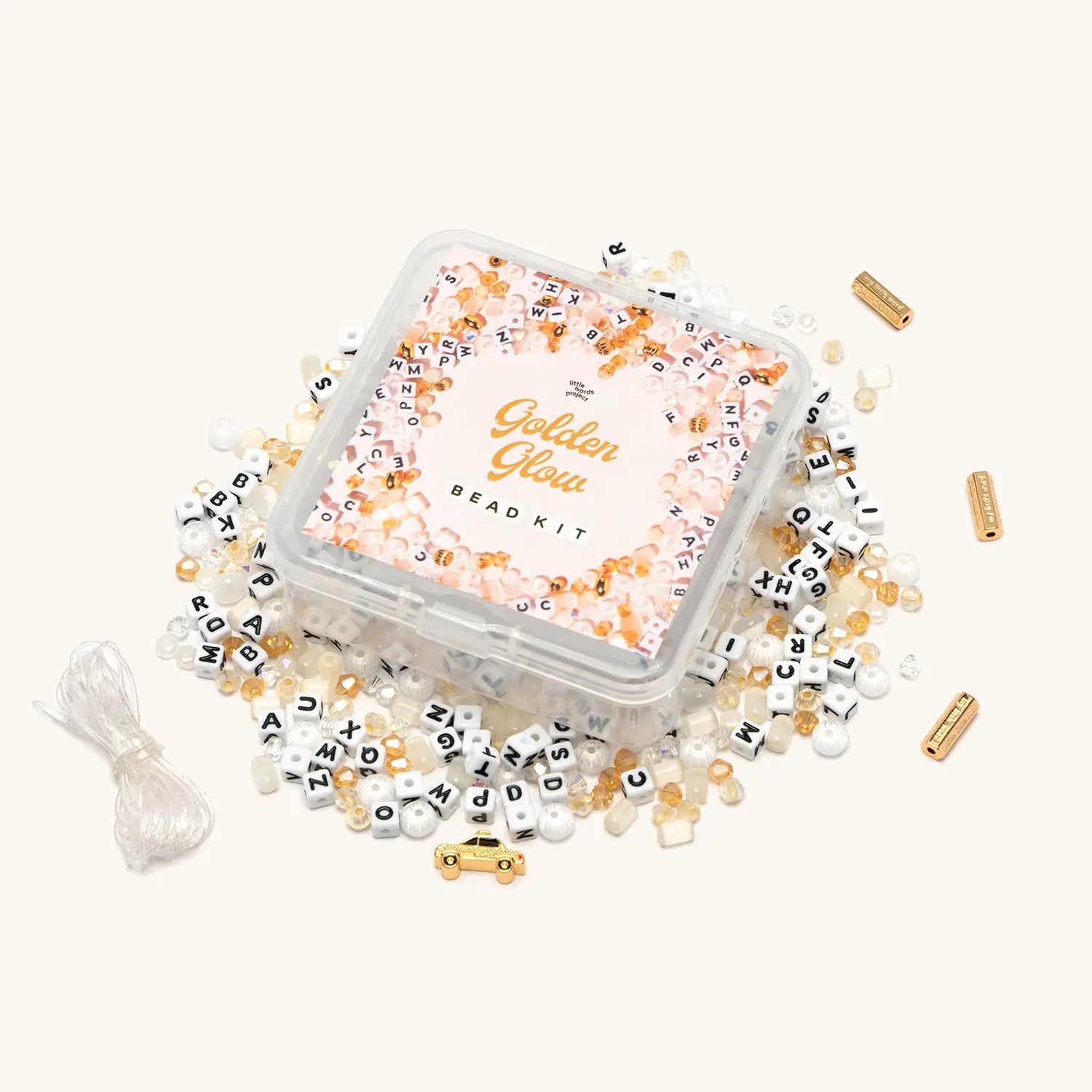 Golden Glow Bead Kit with gold and cream beads spilled around clear storage box