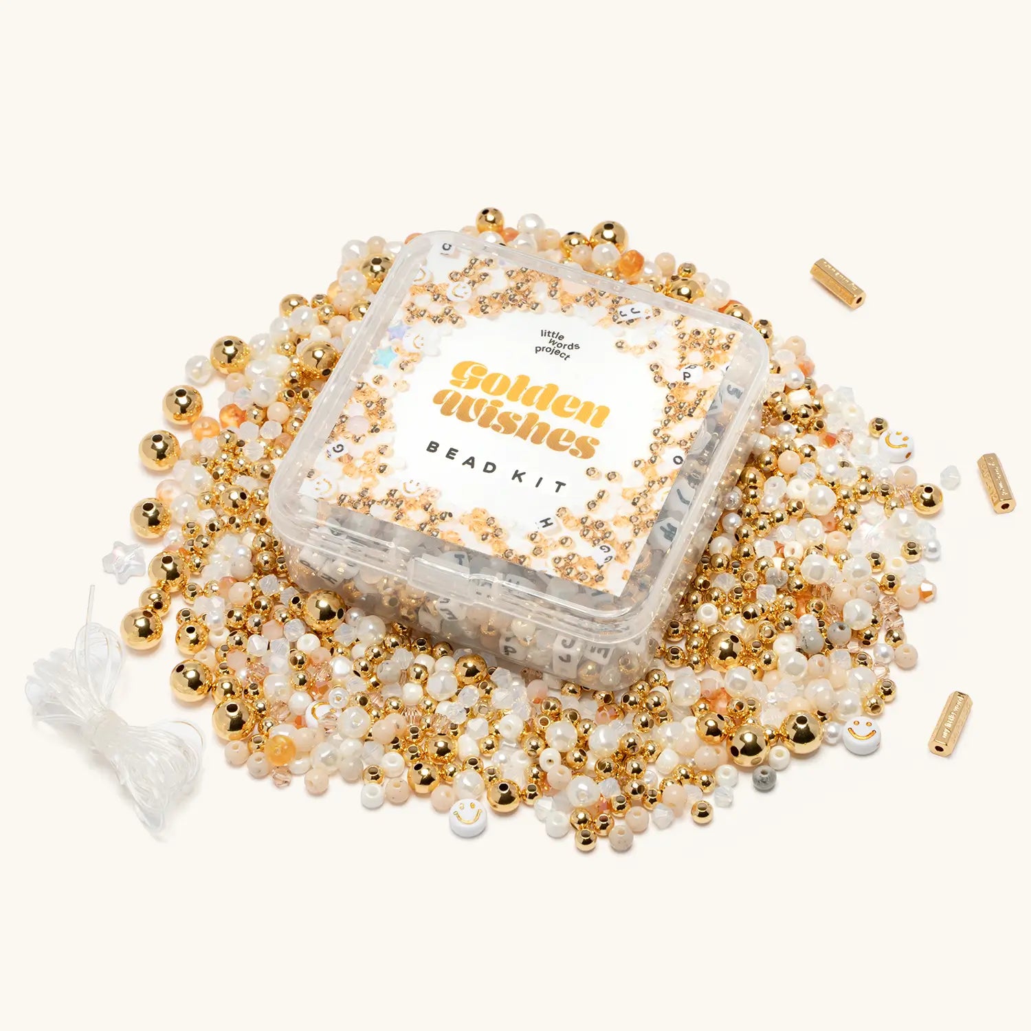 Golden Wishes Bead Kit flat-lay of gold-plated beads, crystals, and accent beads spread out on a white background