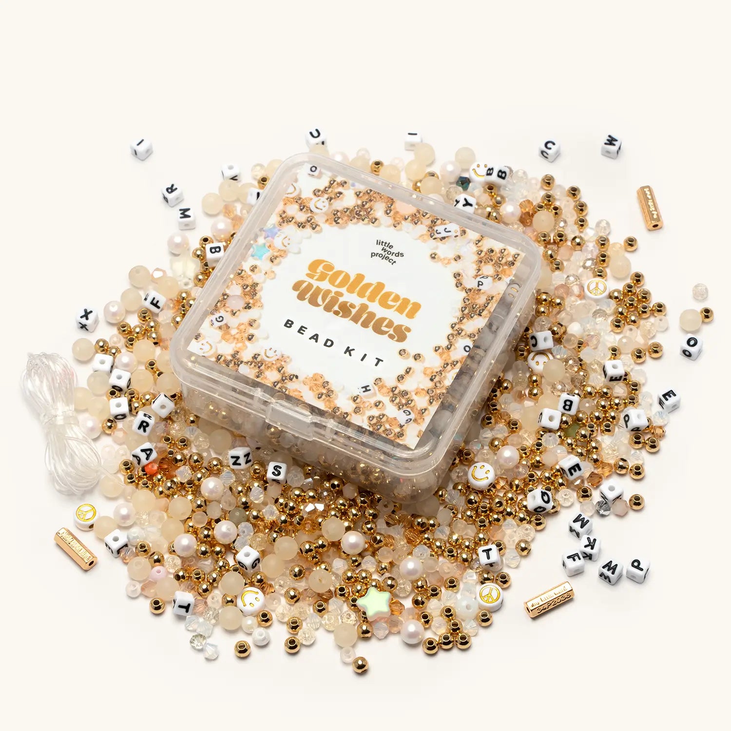 Golden Wishes Bead Kit contents flat-lay showing gold-toned letter beads, star beads, and warm-toned crystal beads