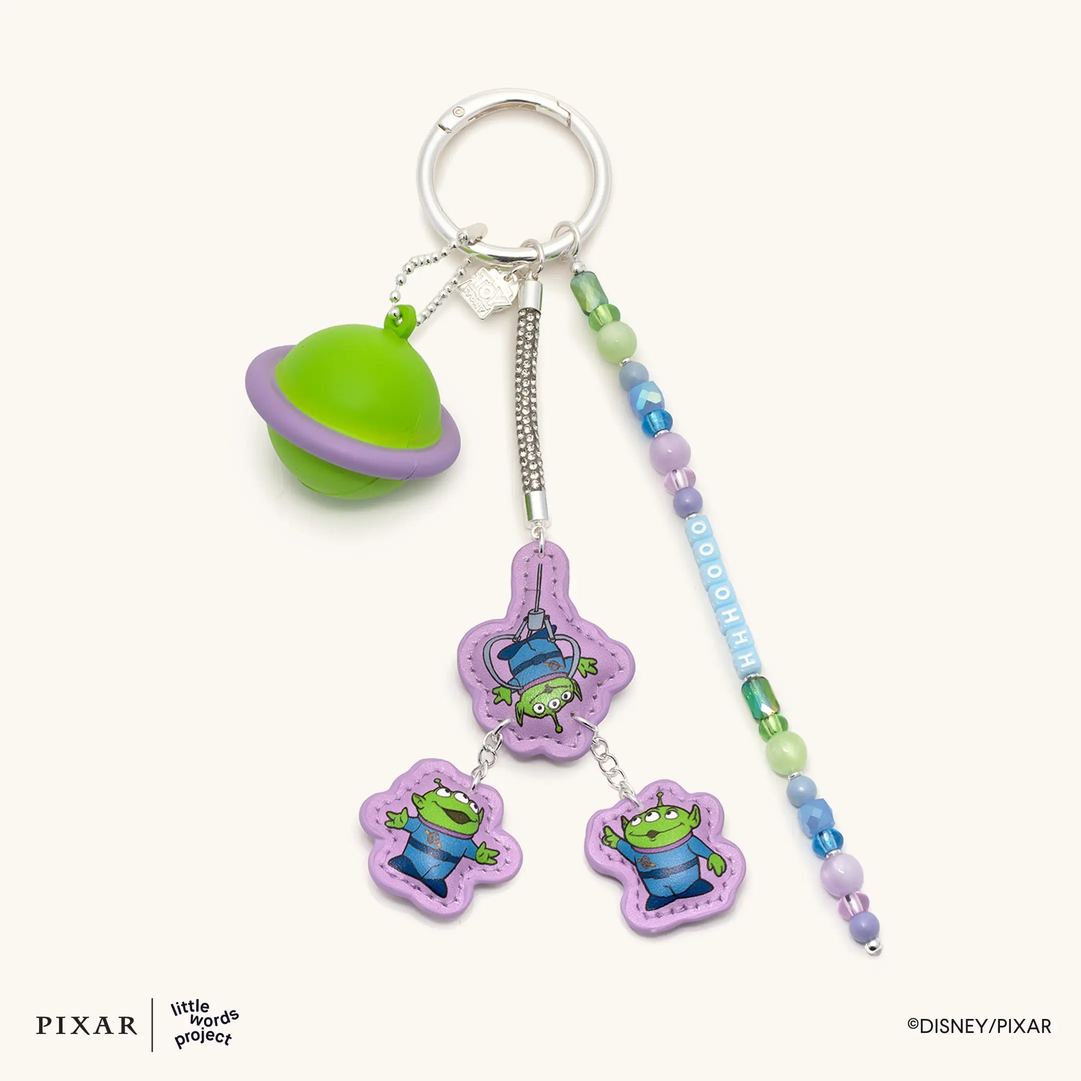 Oooohhhh Aliens Toy Story bag charm, green planet and alien charms on a beaded strand, flat lay
