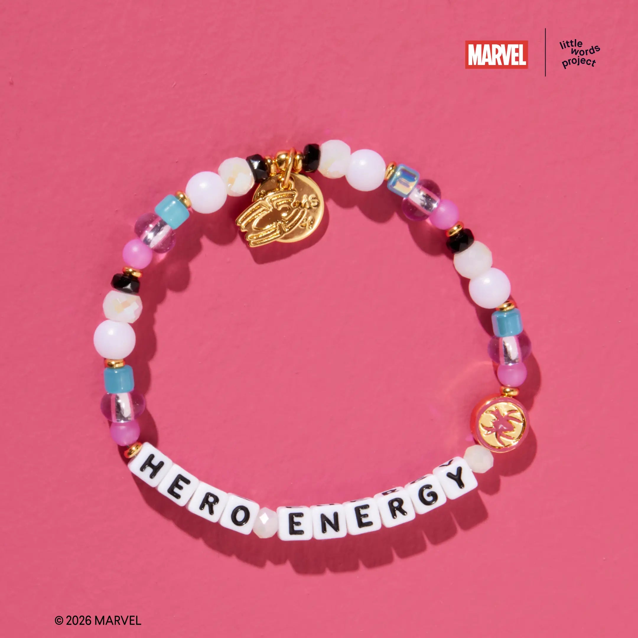 Hero Energy bracelet from Marvel's Spider-Man collection, flat-lay on pink background, white, pink, and blue glass beads with gold Spider-Man casted bead