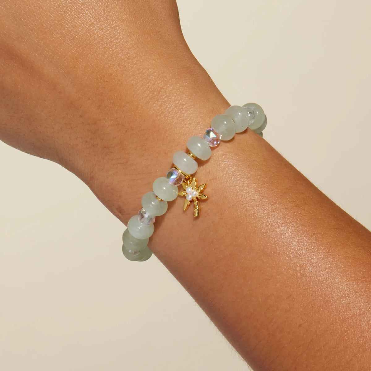 Palm Tree Charm Bracelet Alexia Del Valle worn on wrist with sea green stone beads and gold palm tree charm
