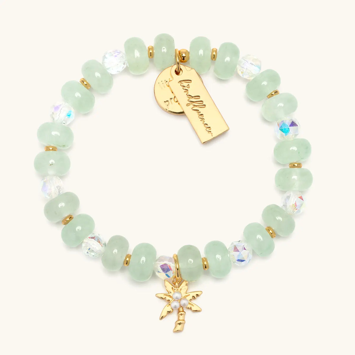 Palm Tree Charm Bracelet Alexia Del Valle flat lay with sea green stone beads, clear crystals, and gold palm tree charm