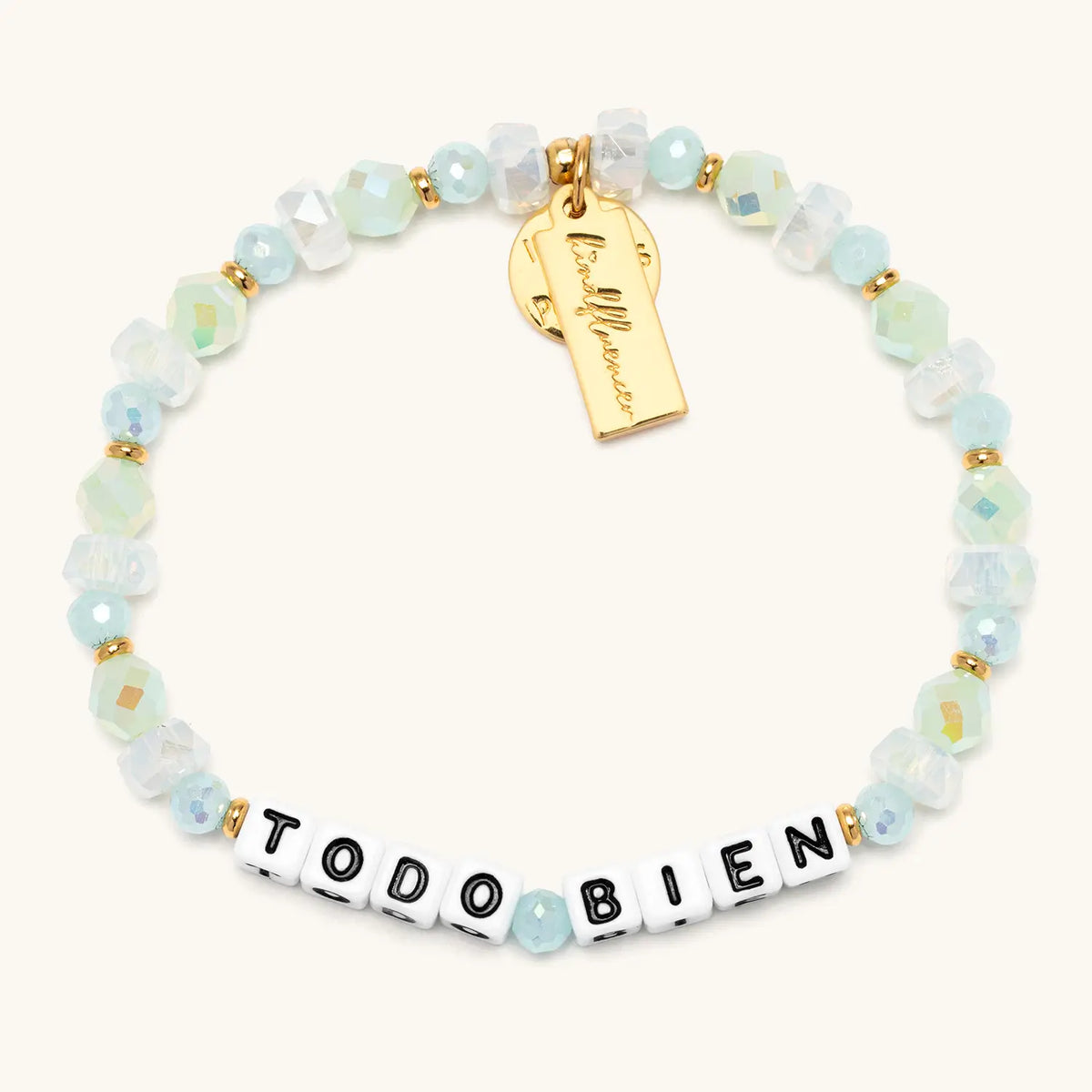 Todo Bien Alexia Del Valle bracelet flat lay with mint green and opal white beach glass beads, white letter beads, and gold accents