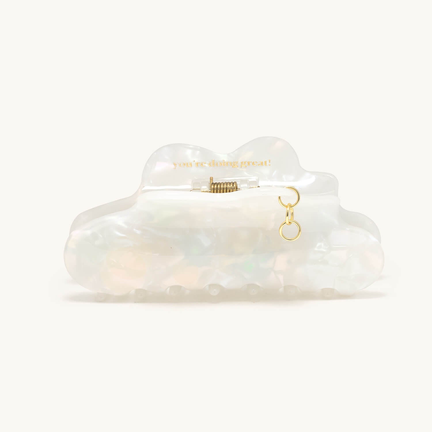 Clear cloud-shaped hair clip with gold charm holder on a white background