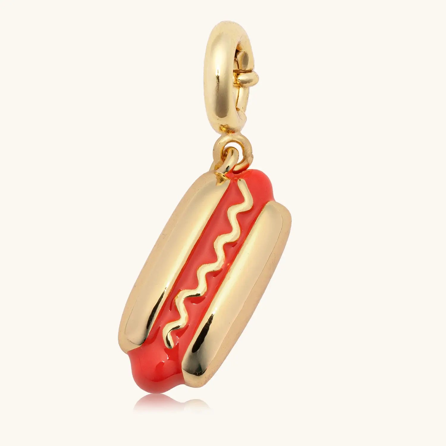 Hot dog-shaped charm with gold casing on a white background