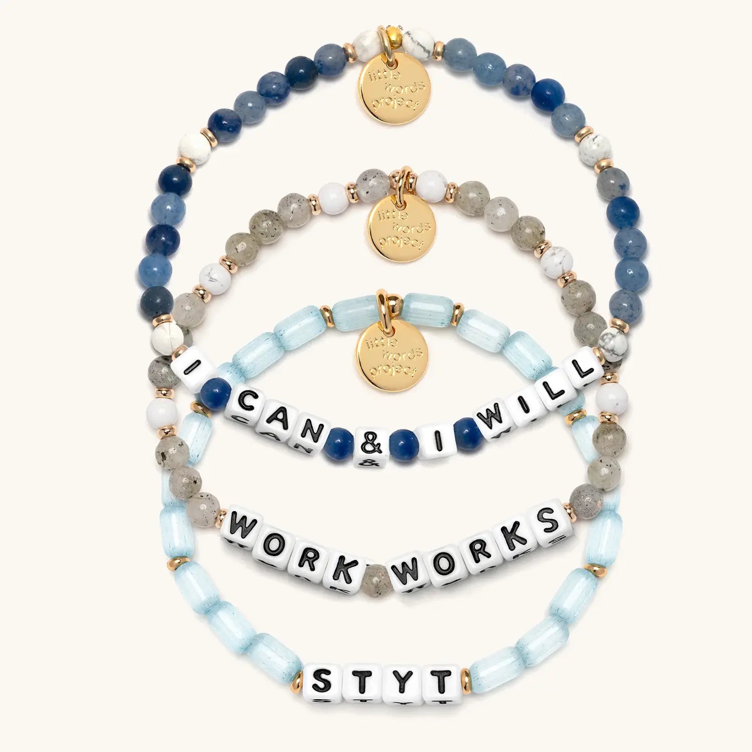 Set of beaded bracelets with motivational phrases on a white background