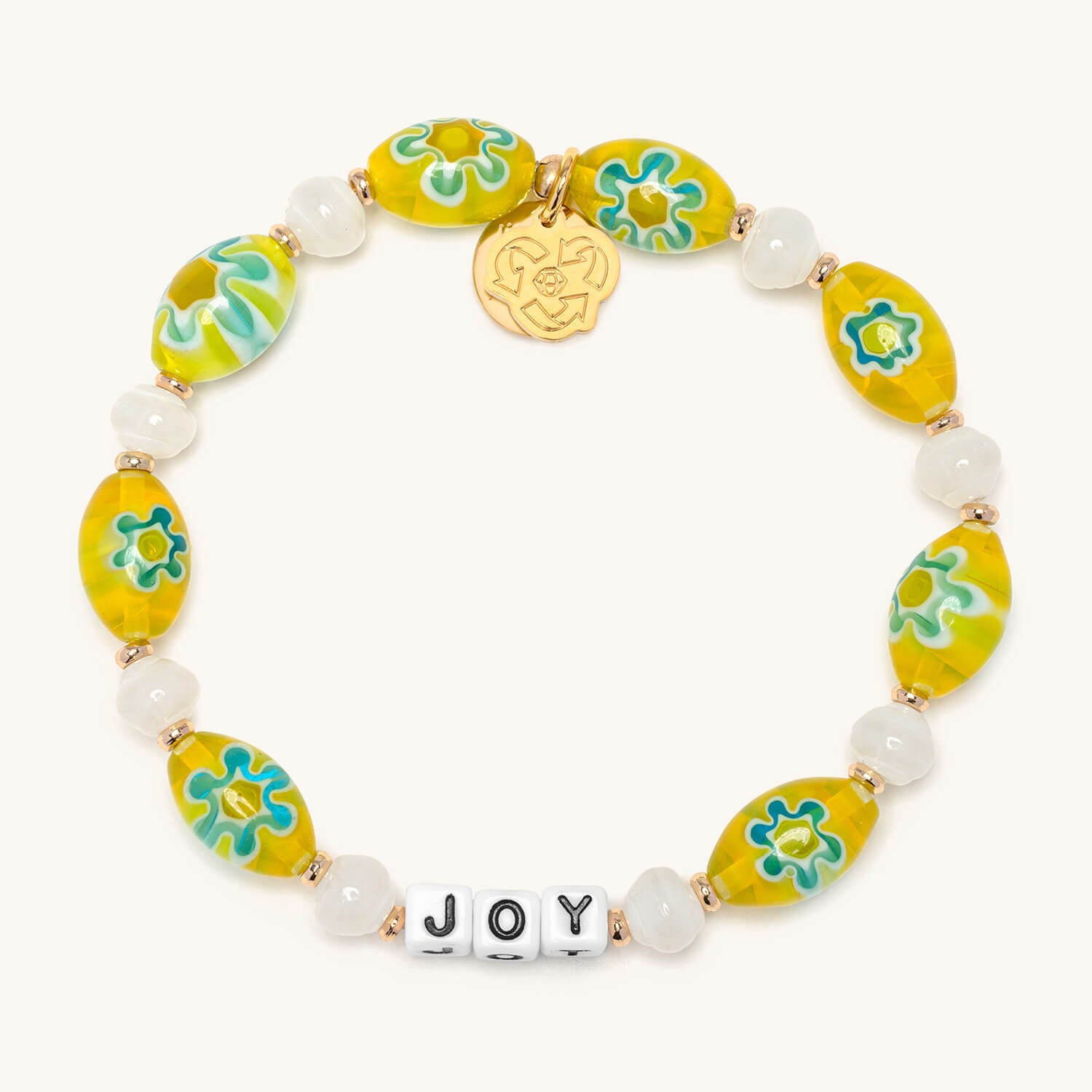 Bracelet with yellow and green floral beads and a gold tag on a white background