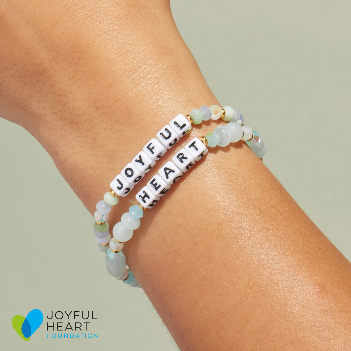 Joyful and Heart bracelets stacked on wrist - Joyful Heart Foundation