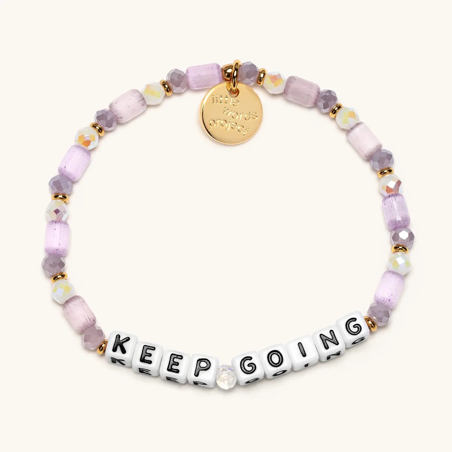 Bracelet with purple beads and 'KEEP GOING' on a white background
