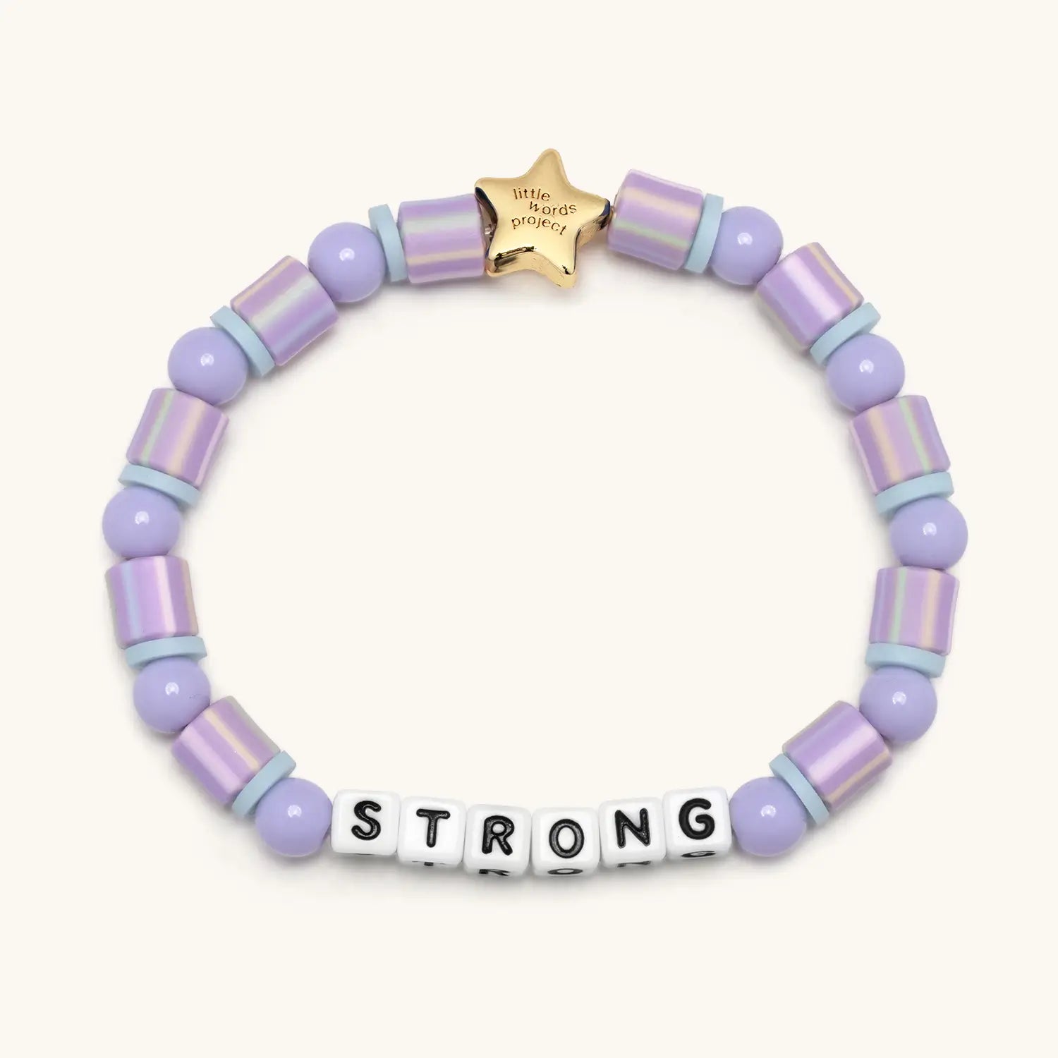 Lavender beaded bracelet with a gold star tag and letter beads spelling 'STRONG' on a white background