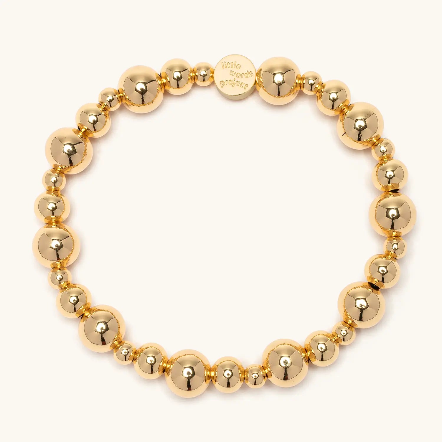 Gold Bubbles bracelet base, gold plated brass beads in alternating sizes with a gold Little Words Project logo tag