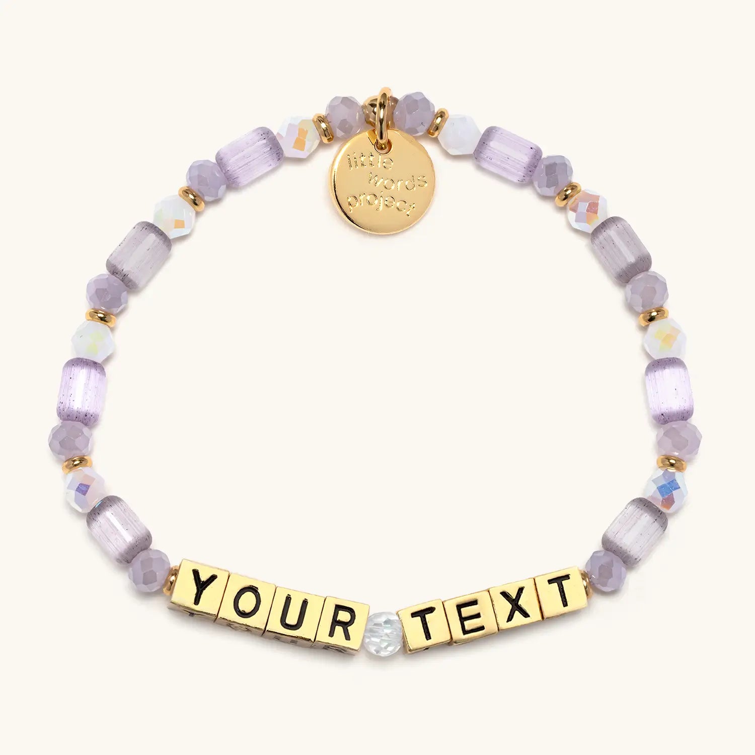 Personalized bracelet with gold letters and purple beads on a white background