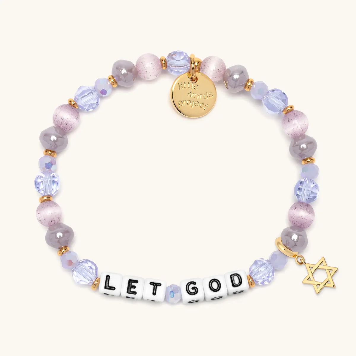 Let God bracelet in the Purple Twinkle bead pattern with white letter beads, gold Star of David charm, flat-lay on cream background