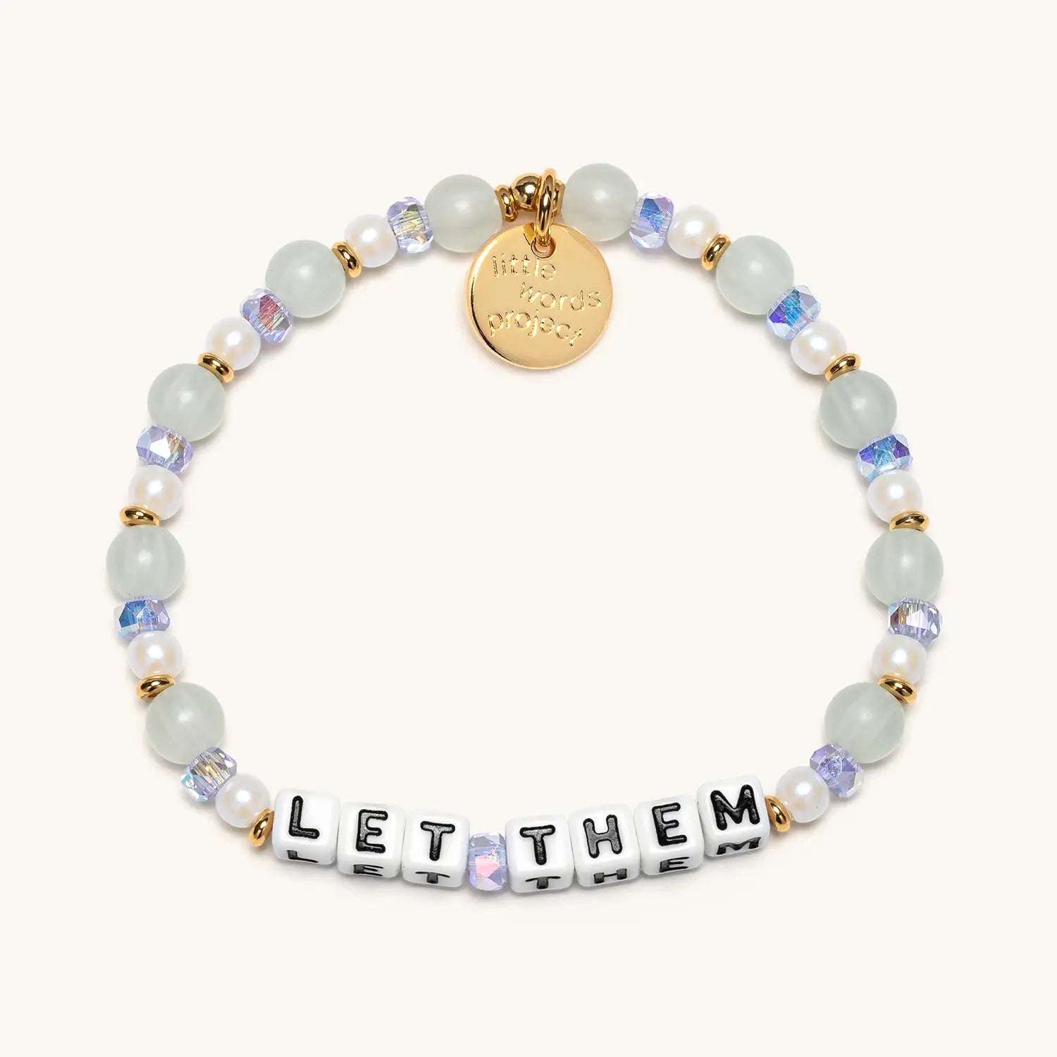 Beaded bracelet with letter beads spelling 'LET THEM' on a white background