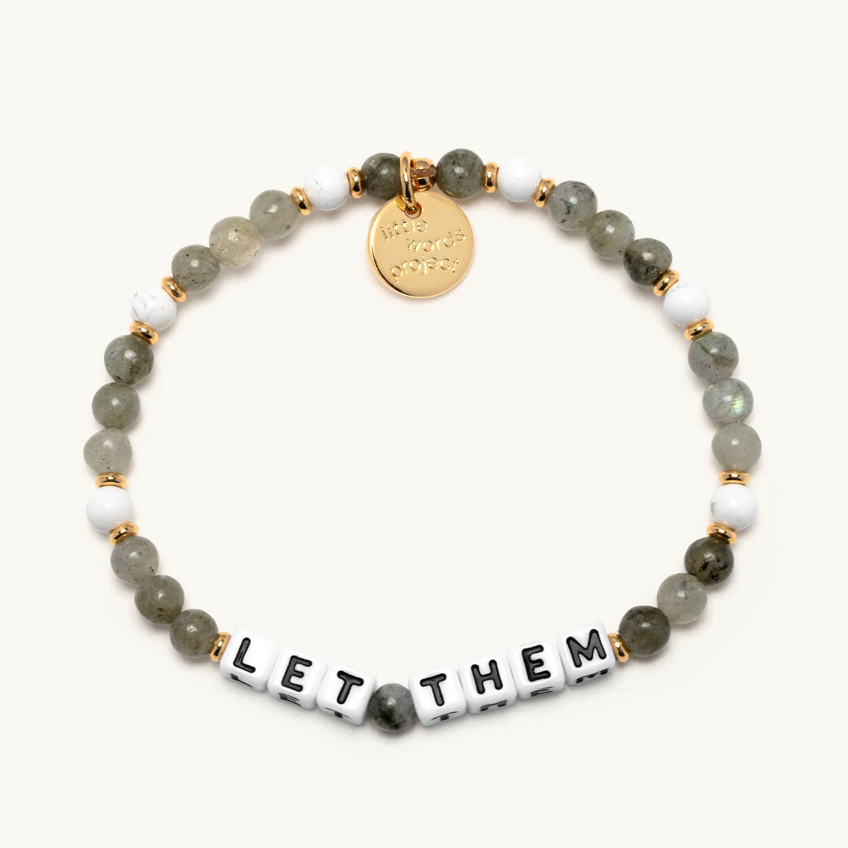 Let Them bracelet with white letter beads from The Reset Bracelet Set, flat-lay on cream background