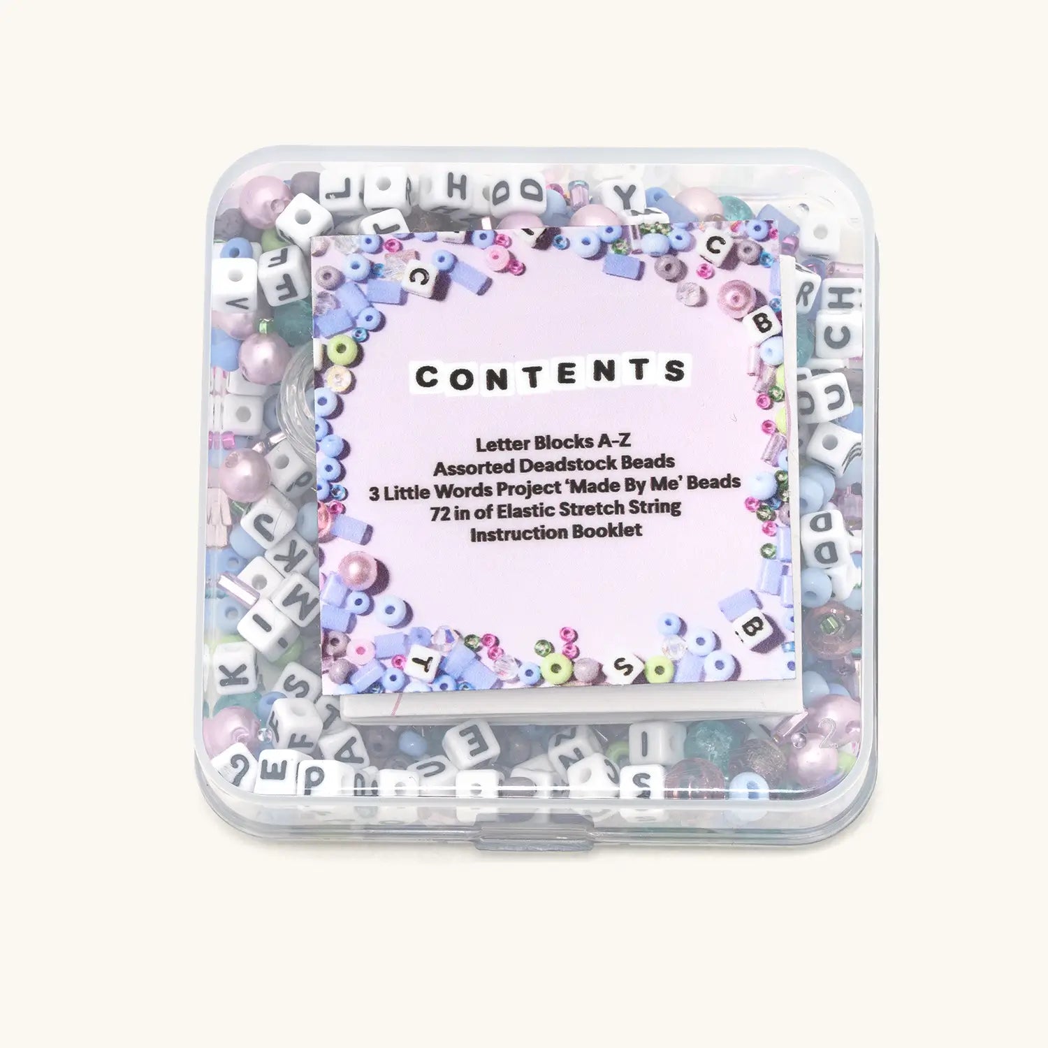 Container of letter blocks and beads with a clear lid showing text.