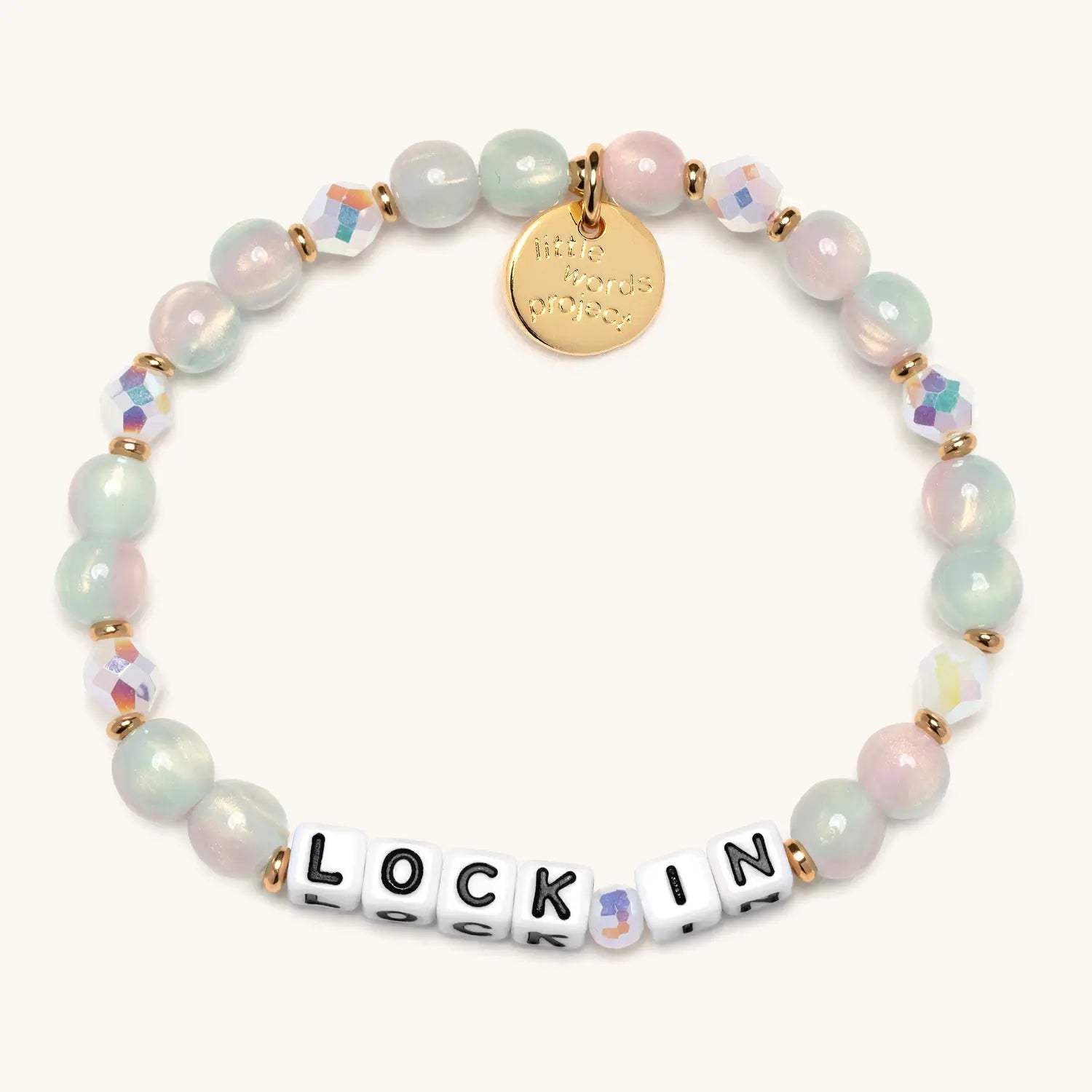 Multicolored beaded bracelet with a gold tag and letter beads spelling 'LOCK IN' on a white background
