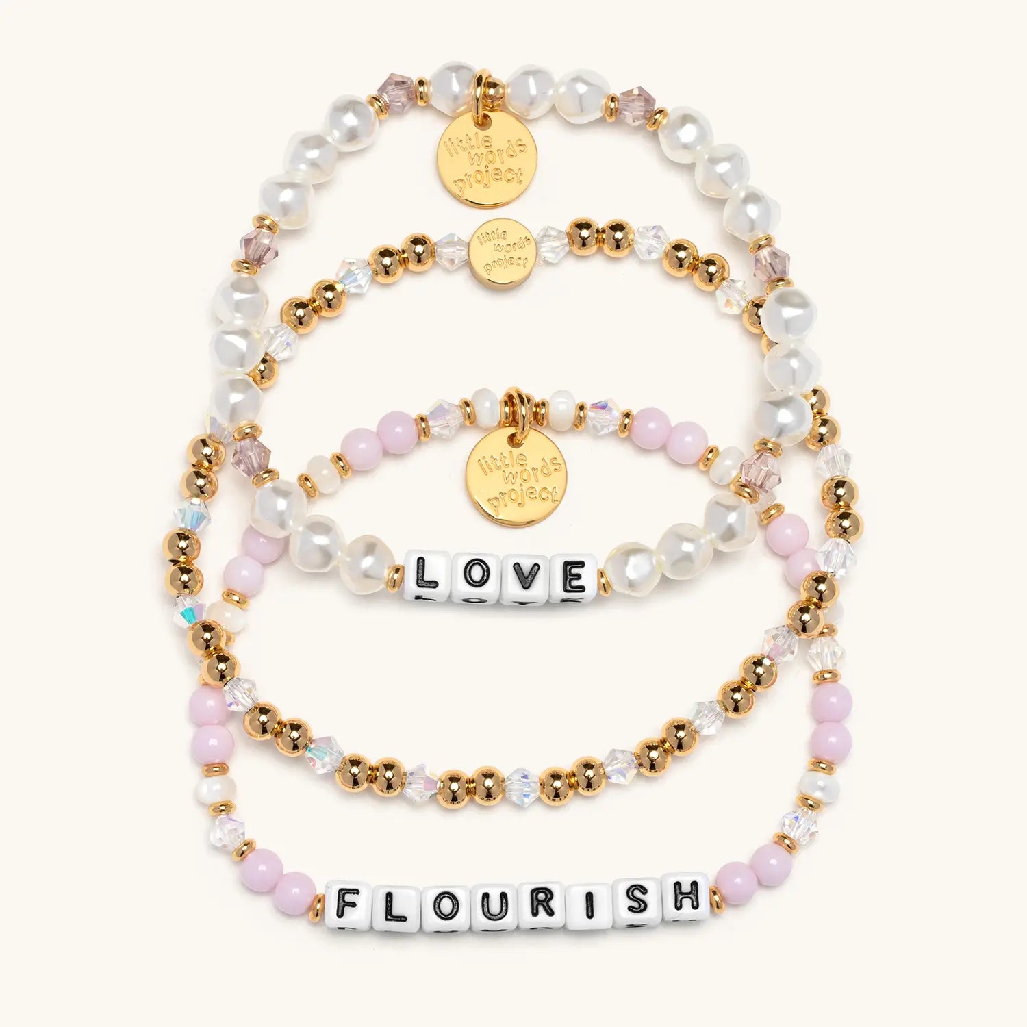 Set of beaded bracelets with 'LOVE' and 'FLOURISH' on a white background
